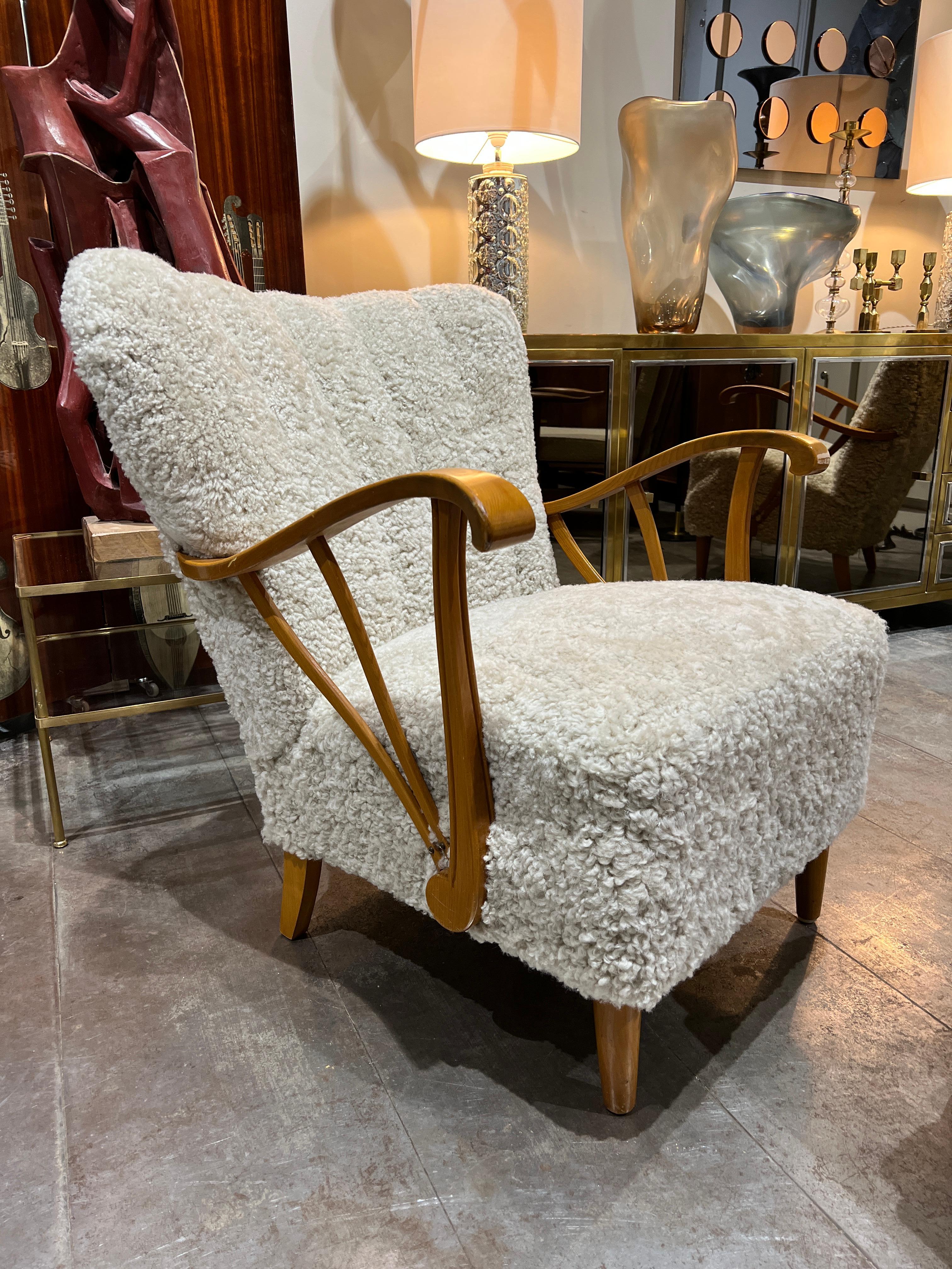 A pair of 1950 Swedish armchairs newly upholstered with sheepskin 
