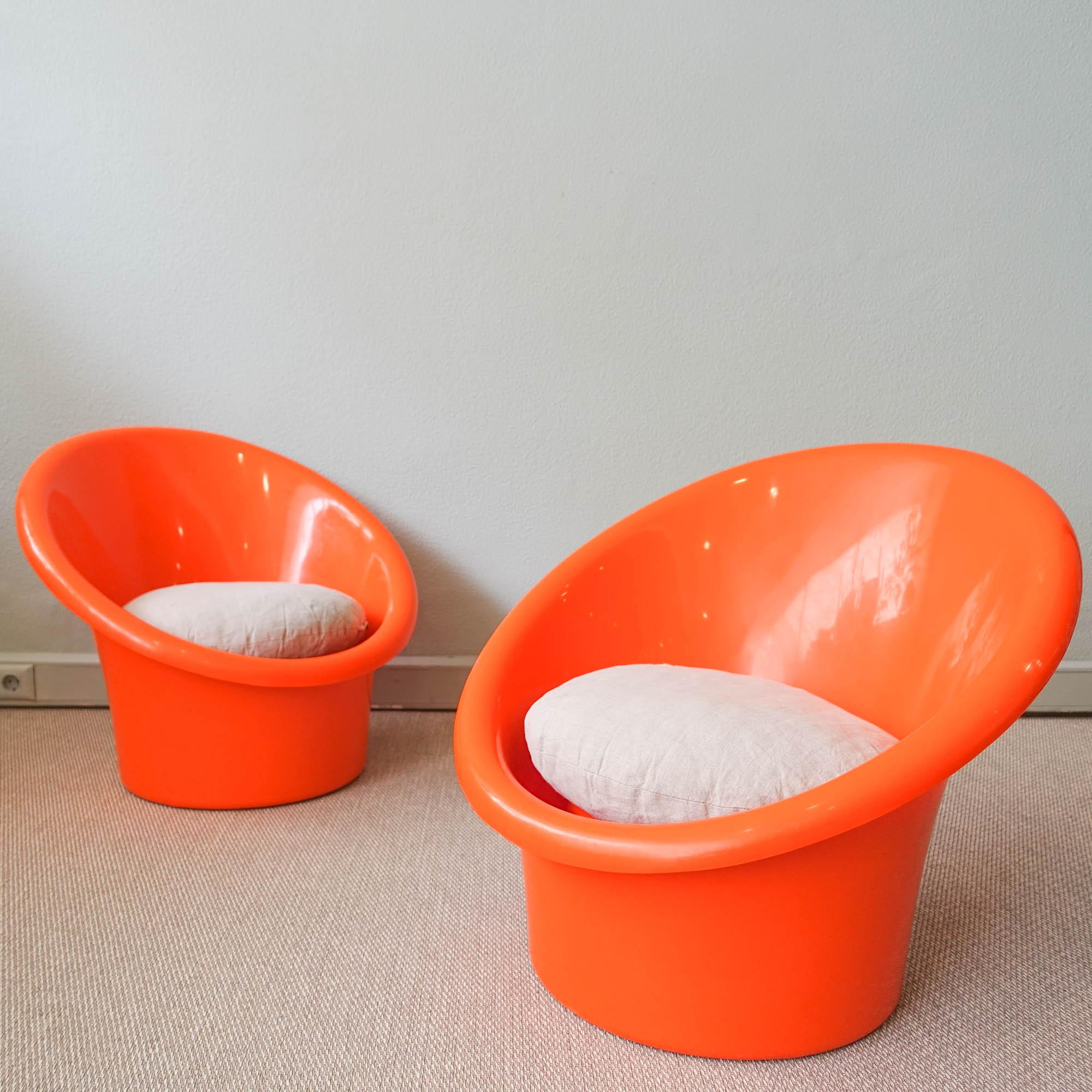 Skopa easy chair was designed by Danish duo Ole Gjerlov-Knudsen & Torben Lind, and produced by Orth Plast for IKEA, in Denmark, during the 1970's. Each chair has an orange plastic shell with loose seat cushion. Can be used for inside or outside. In