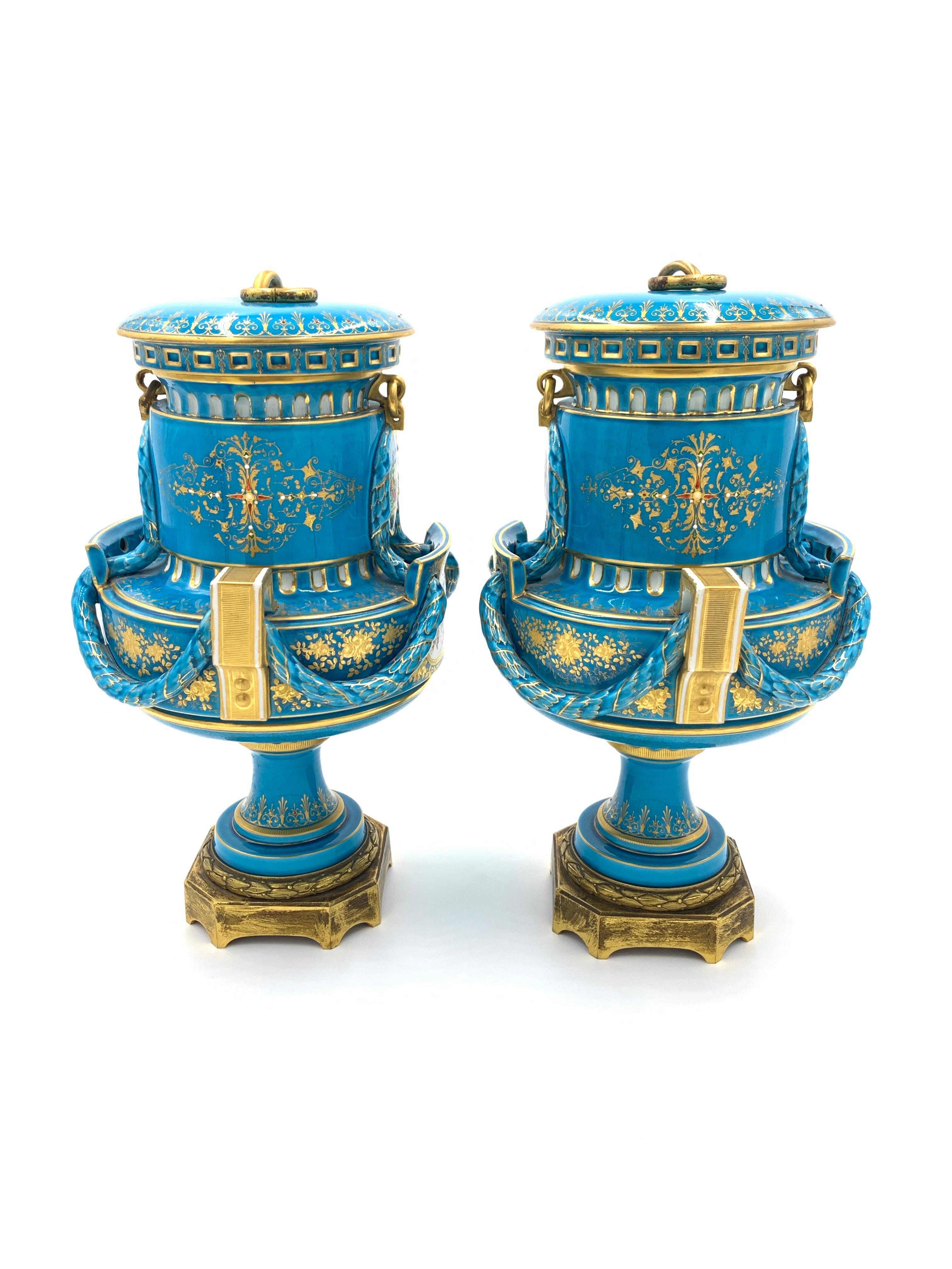 19th century sky blue sevres style vases with gold inlaid, the front of the vases depicts a portrait of two women’s and beneath it a painting for a mother and child in a garden setting while the reverse of the vases depicts exceptional birds.
 