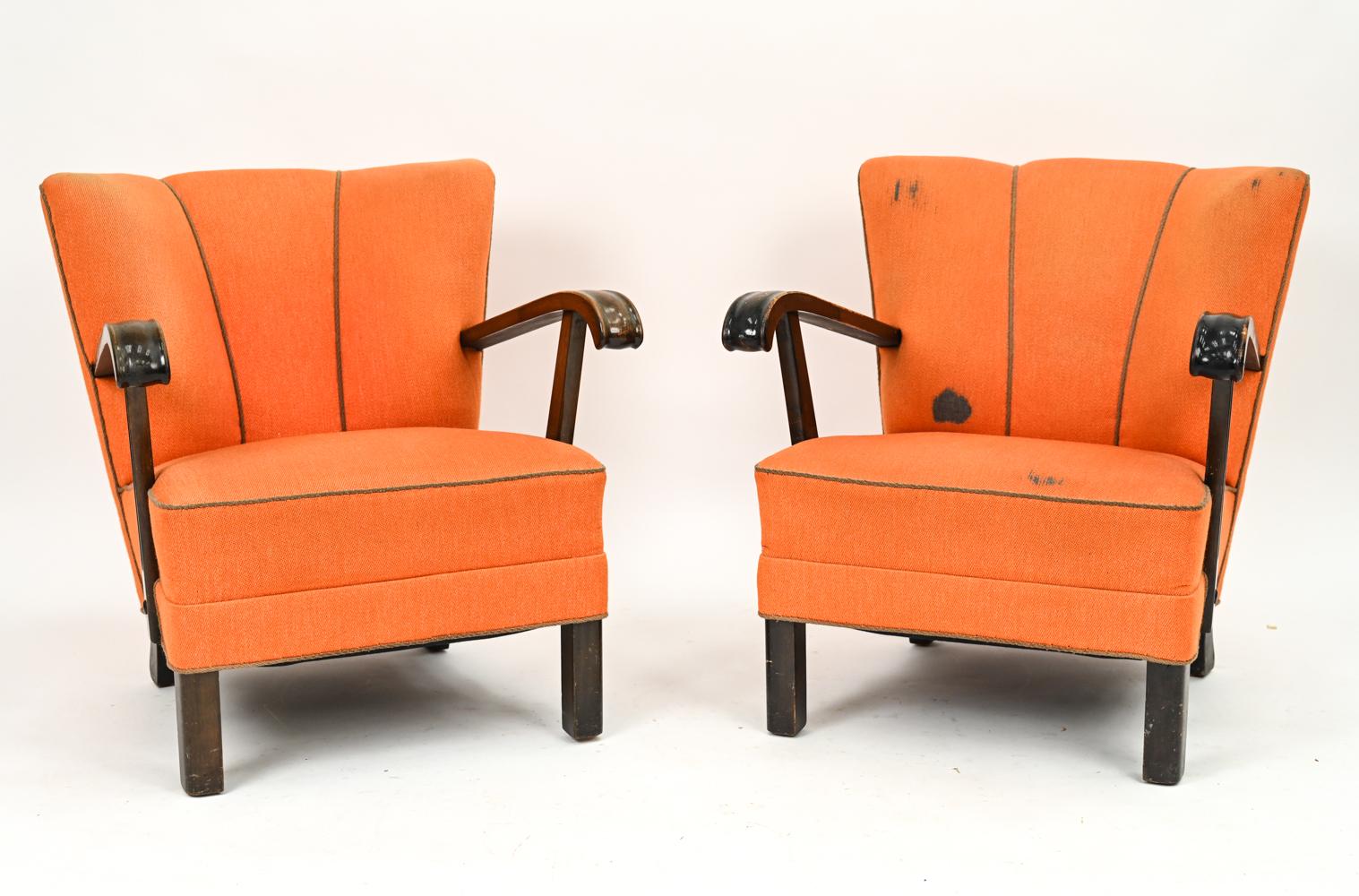 An elegant pair of early Scandinavian modern easy chairs by Slagelse, boasting design and sturdy craftsmanship of the highest caliber. These handsome chairs mark the transition from traditional design to Danish mid-century, with traditional carved