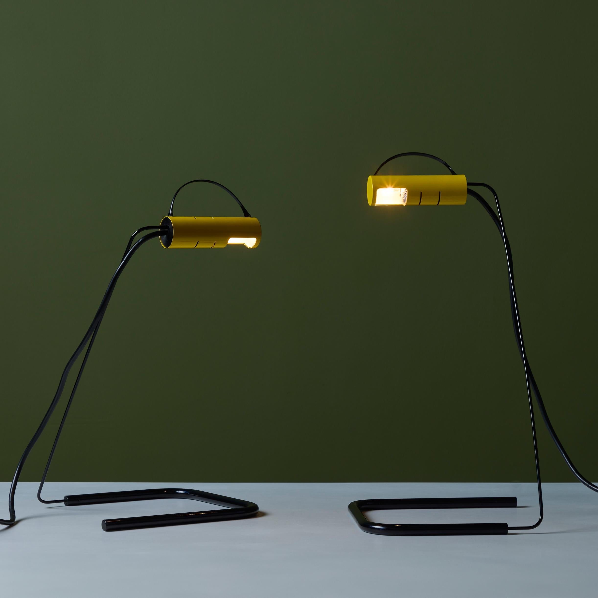 Pair of postmodern table lamps by Vico Magistretti for Oluce, c.1981, Italy. The lamps feature a metal enameled body and shade in both black and yellow. The shades rotate to offer directional lighting.

Dimensions
10