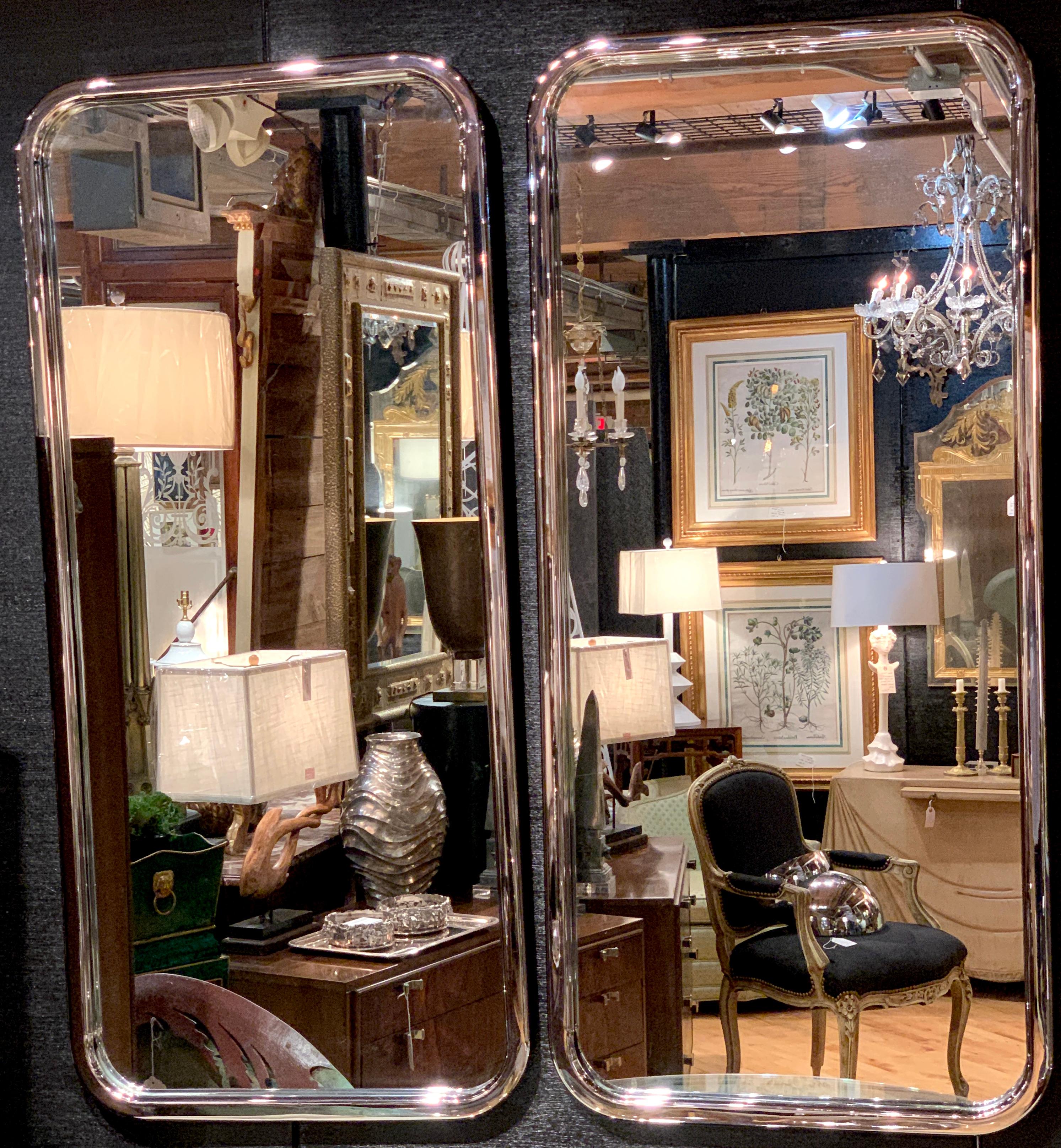 Pair of sleek Italian 1970s chrome mirrors, each one with seamless polished chrome frames, and inset mirror. High caliber, heavy casting. Each mirror measures 52-inches high x 23.5-inches wide, with a depth of 1.5-inches.


 