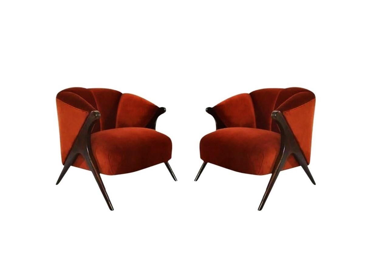 Infuse your home with this luxurious pair of modernist Karpen lounge chairs. Perfectly proportioned each boasting a sculptural barrel silhouette with a bold, modern edge. The chairs are set apart by their unique construction. Its rounded back curves