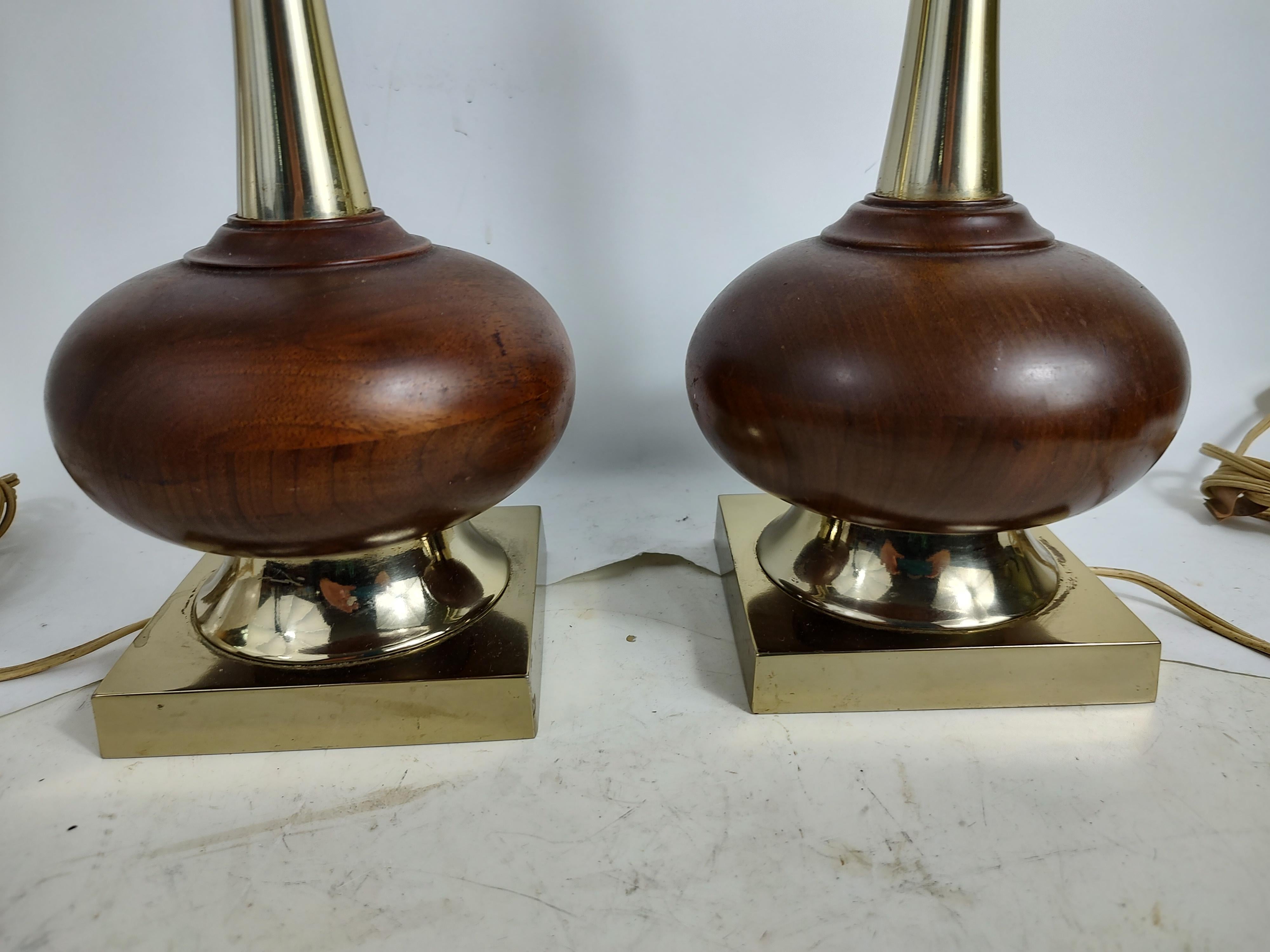 Fabulous pair of Mid-Century Modern Sculptural table lamps attributed to the Laurel Lamp Co. Tall slender necks supported by a squat walnut ball. In excellent vintage condition with minimal wear. Both lamps have touch sensors installed. Touch stems