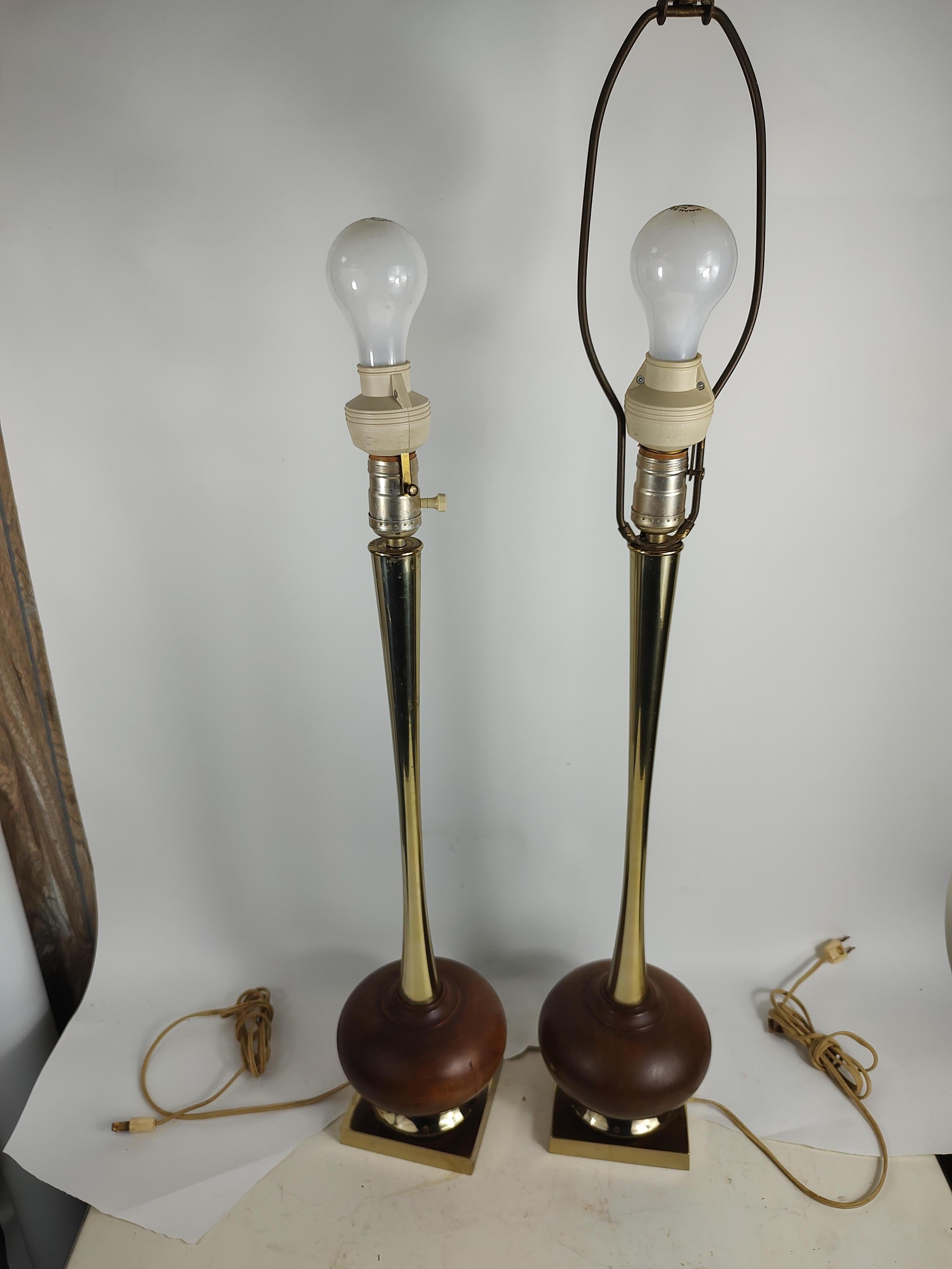 Fabulous pair of Mid-Century Modern Sculptural table lamps attributed to the Laurel Lamp Co. Tall slender necks supported by a squat walnut ball. In excellent vintage condition with minimal wear. Both lamps have touch sensors installed. Touch stems