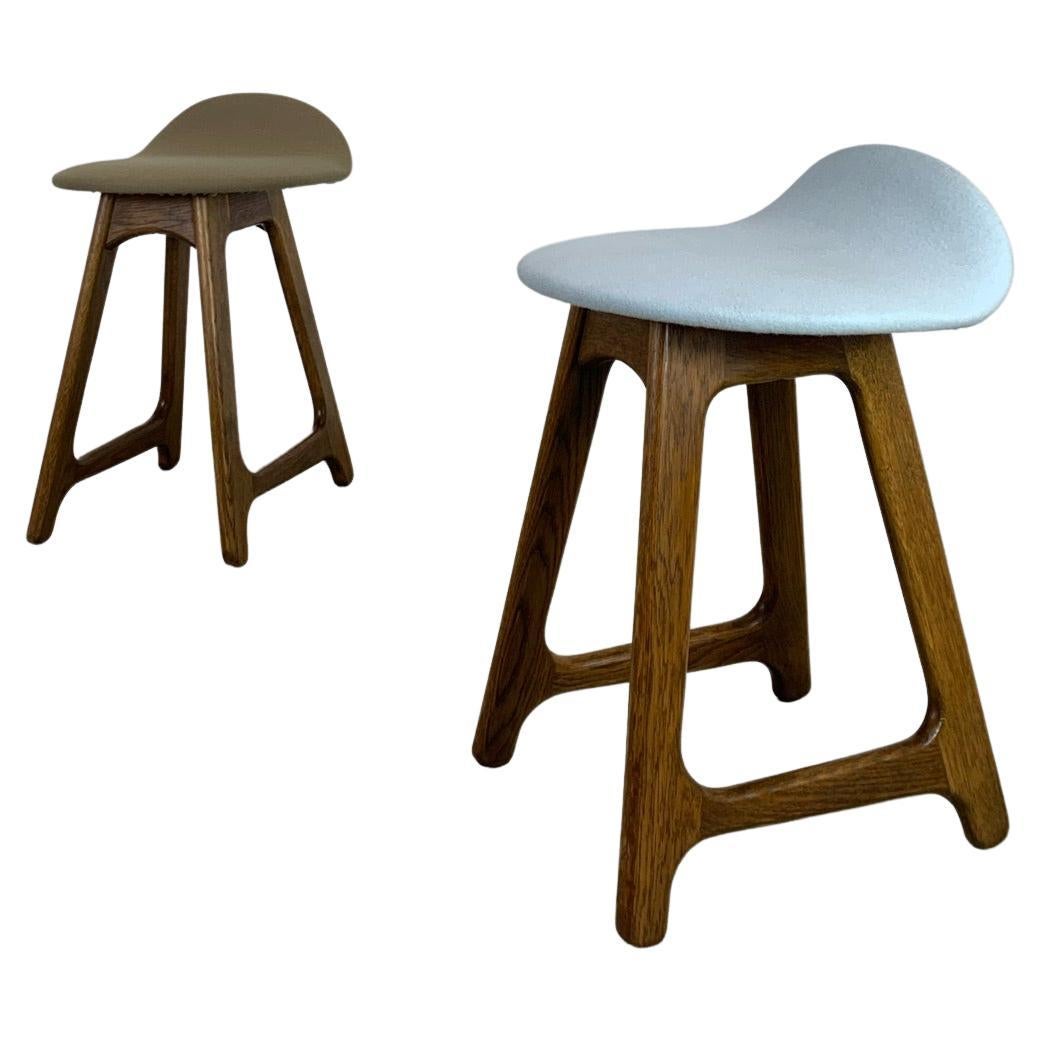 Pair of mid-century stools by Danish Designer Erik Buch. Made in Denmark during the 1950s by O.D. Mobler / Domus Dancia. This is a very rare design classic which maintains the manufacturer’s mark and features a sturdy wooden frame with a slated open