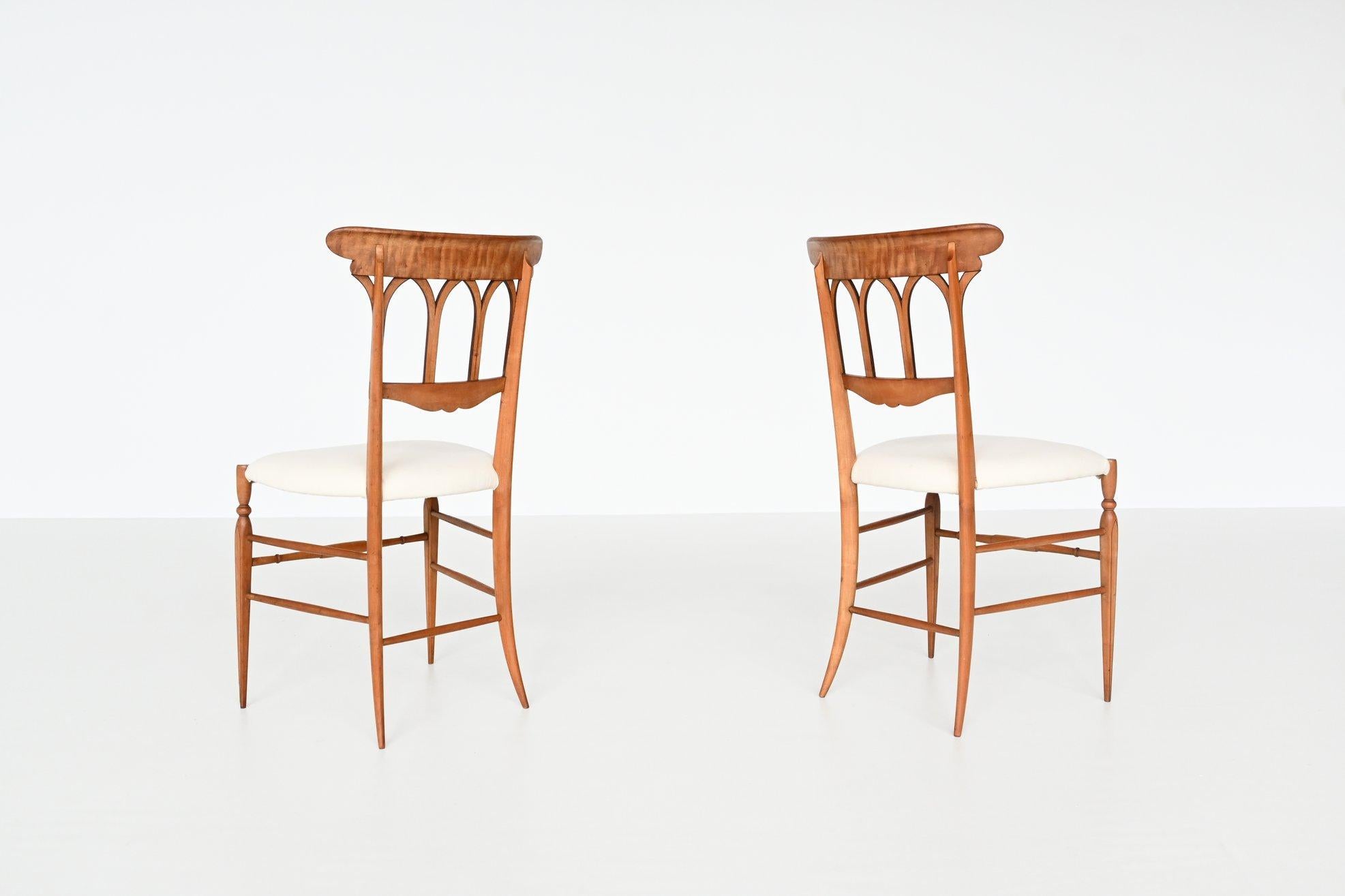 Beautiful pair of elegant Italian chairs by Chiavari, Italy, 1950. Fantastic Italian slim shaped design and amazingly light. These well-crafted chairs have a beech wooden frame and are newly upholstered with white fabric of Kvadrat. They have very
