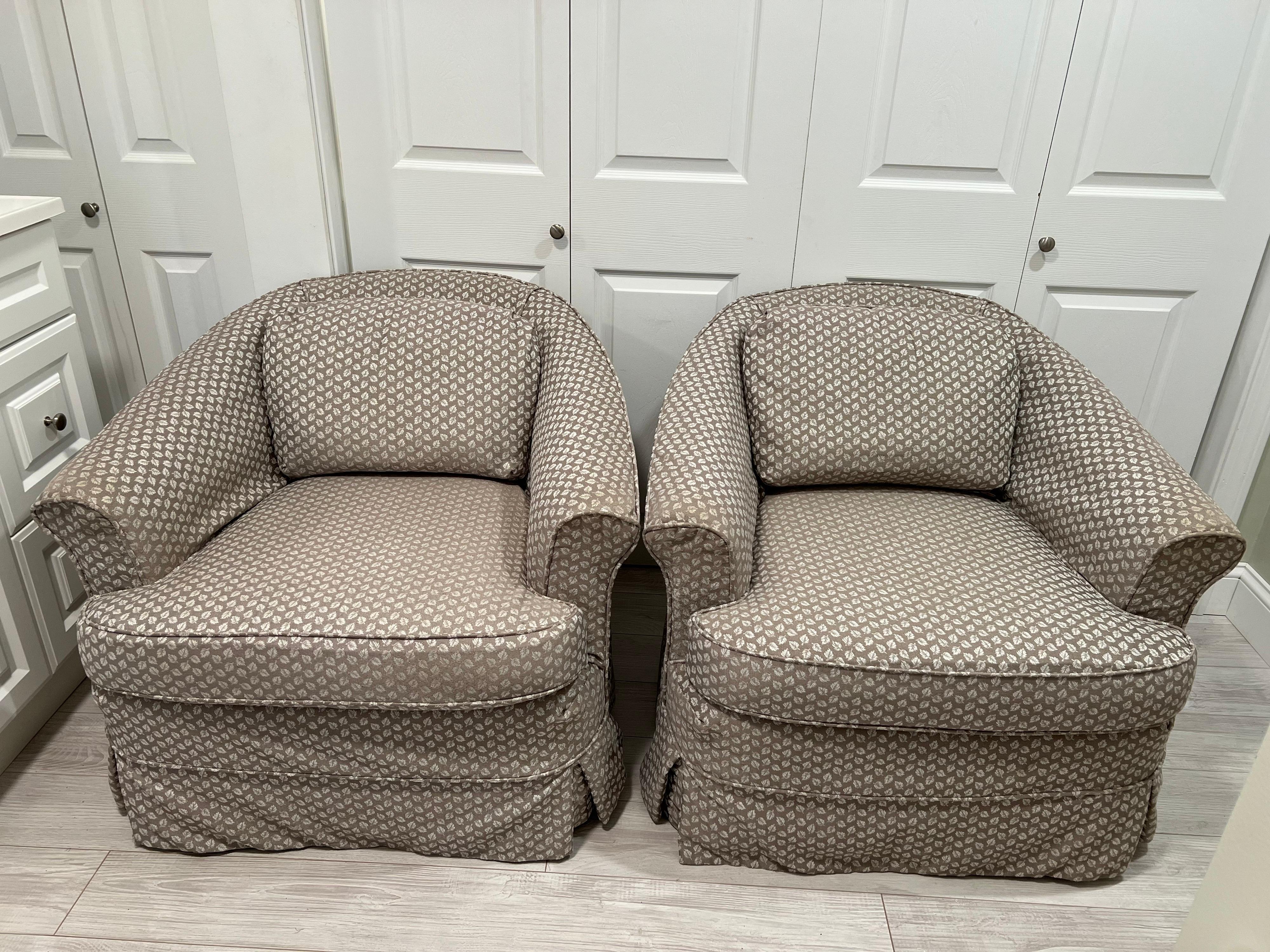 Pair of slip covered club chairs by Drexel. Soft light grey mushroom color geometric fabric slip Cover. Use as is or recover. Classic timeless shape with castors for easy moving. Seat seat width 21