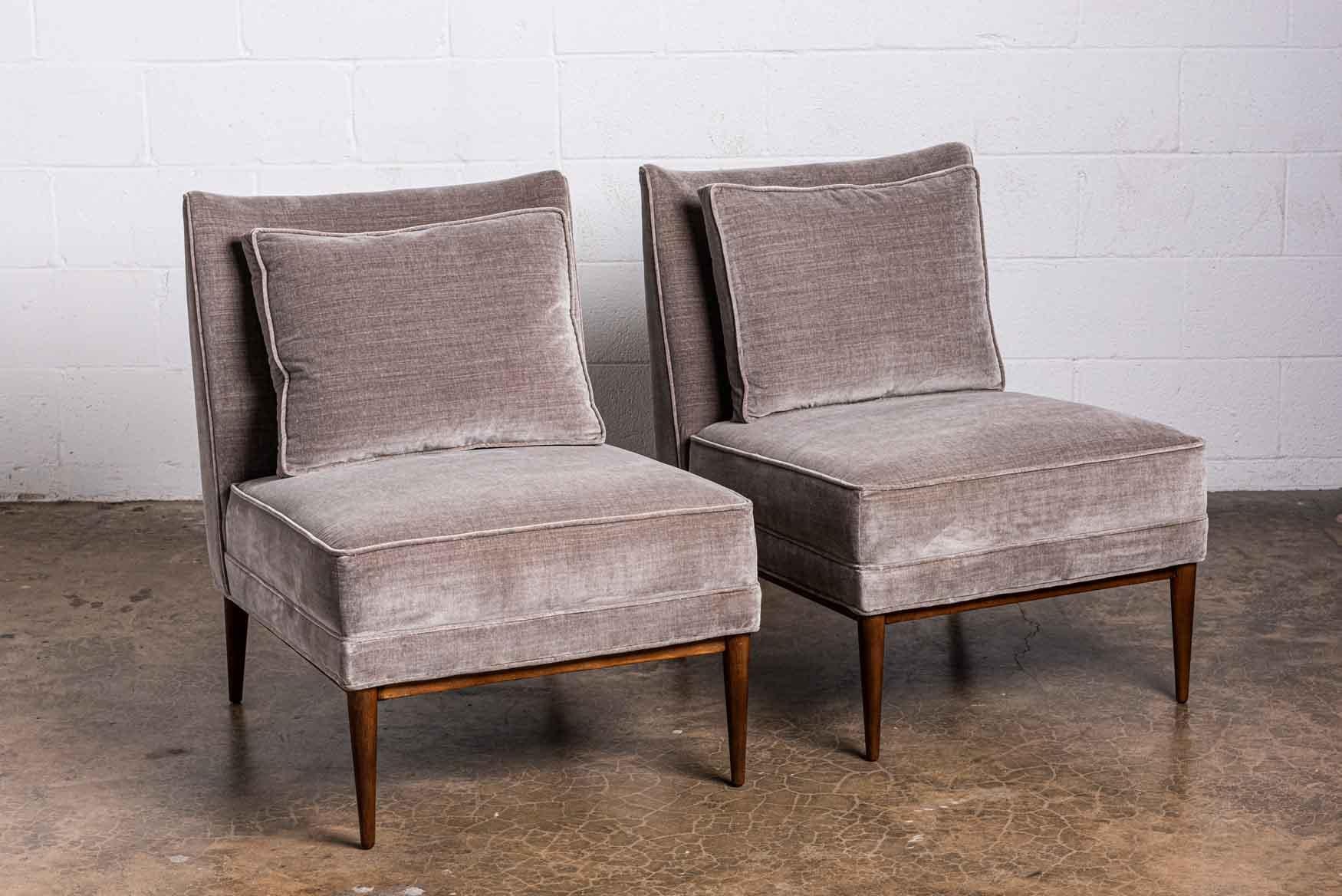 A pair of slipper chairs and ottoman designed by Paul McCobb. 

Chair: 23.5 x 32 D x 31.25 H / 16.5 SH
Ottoman: 24 x 19 x 15.5H.