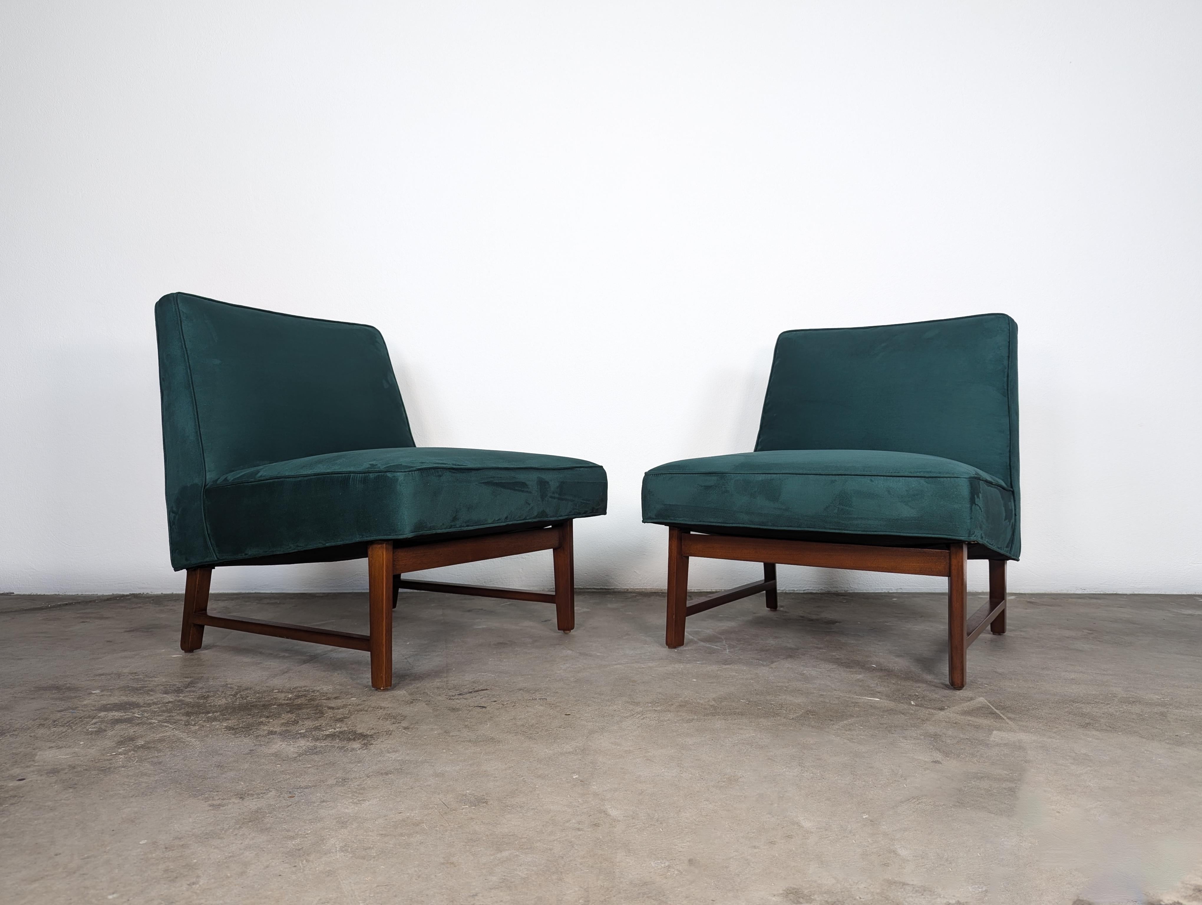 For sale is an exquisite Pair of Slipper Chairs by the renowned designer Edward Wormley for Dunbar, circa 1950s. These iconic chairs have been meticulously refinished and are in overall excellent condition. They have been reupholstered in a soft and
