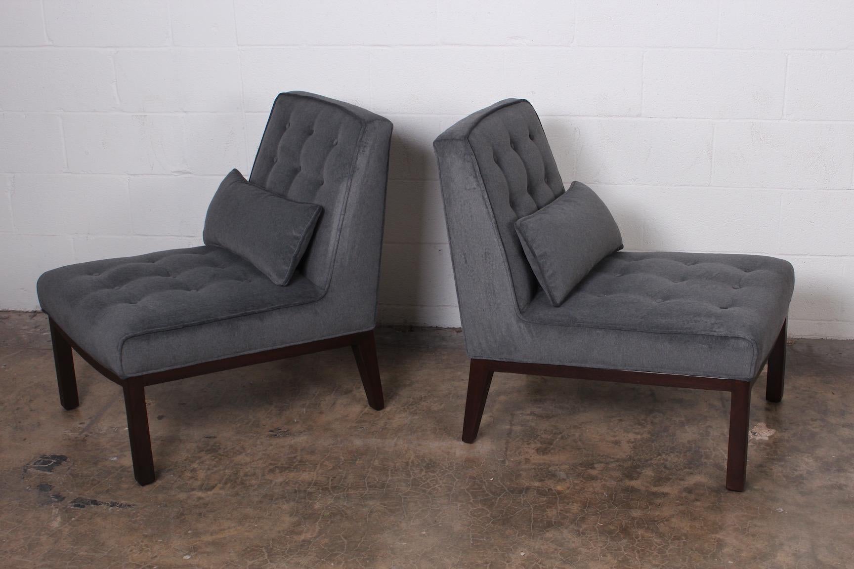 A pair of slipper chairs with mahogany bases. Designed by Edward Wormley for Dunbar.