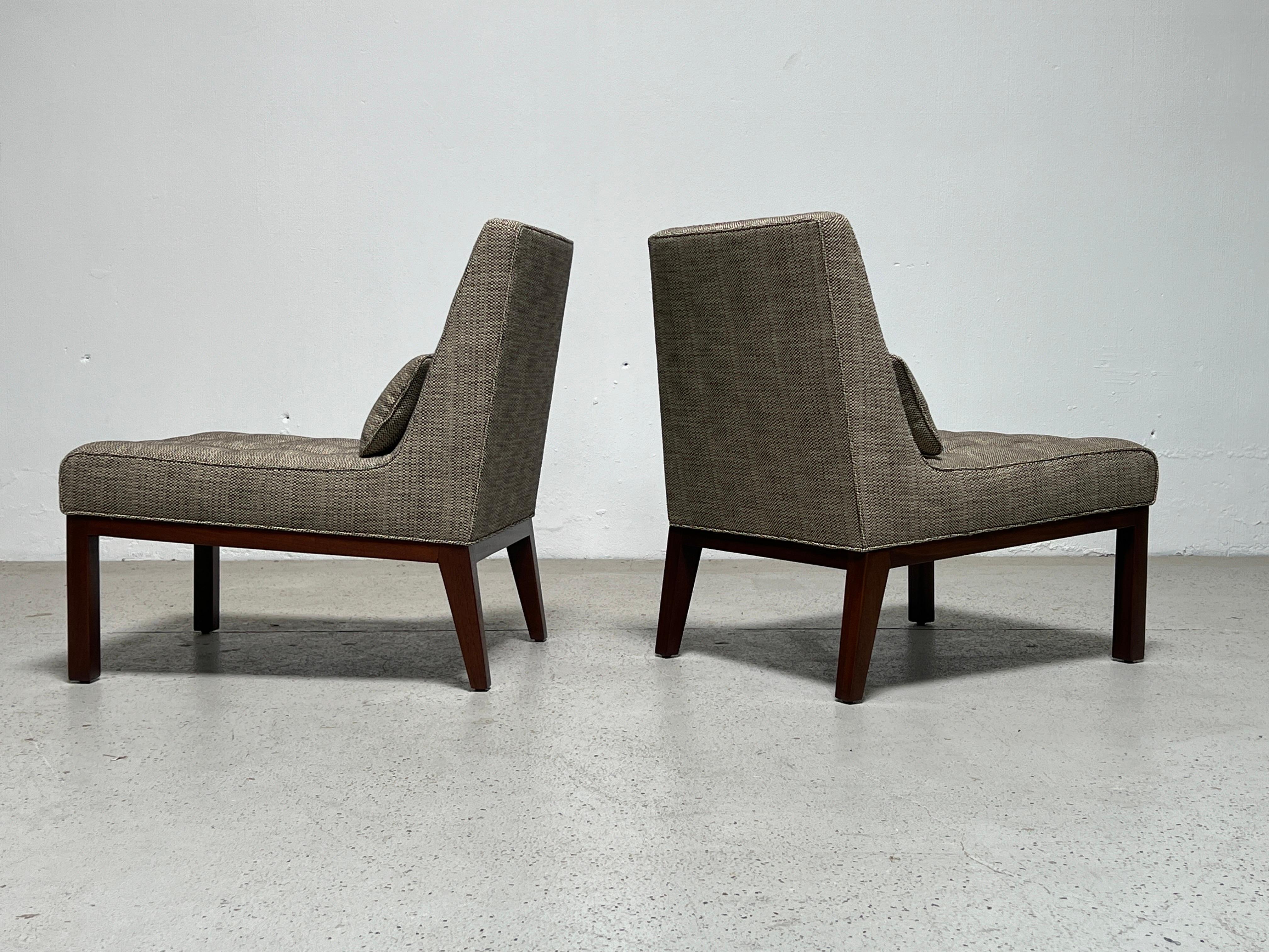 A pair of slipper chairs with mahogany bases. Designed by Edward Wormley for Dunbar.