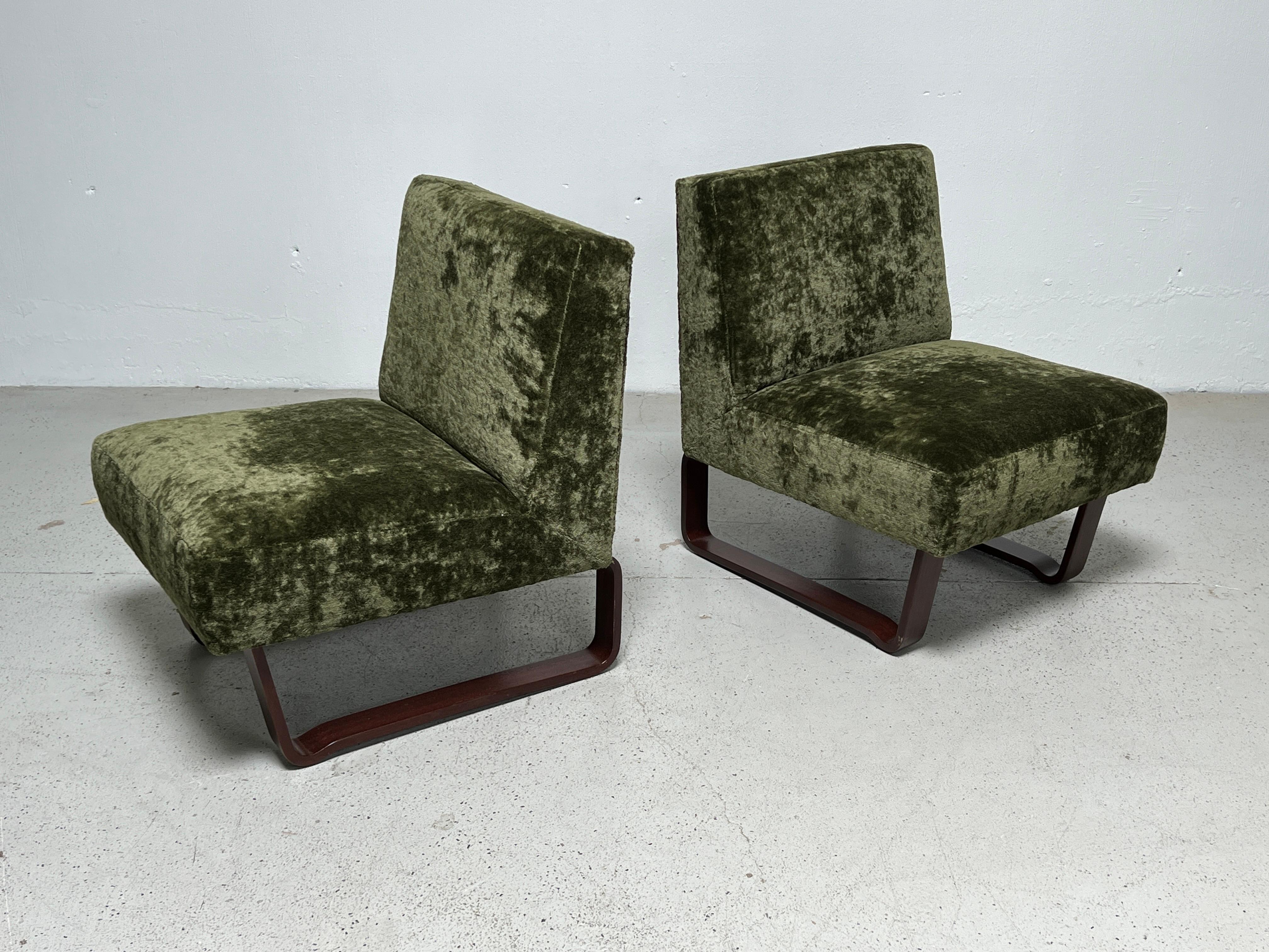 A pair of mahogany sled based slipper / lounge chairs designed by Edward Wormley for Dunbar. Fully restored and upholstered in Holly Hunt / Lush / Palm thick velvet.