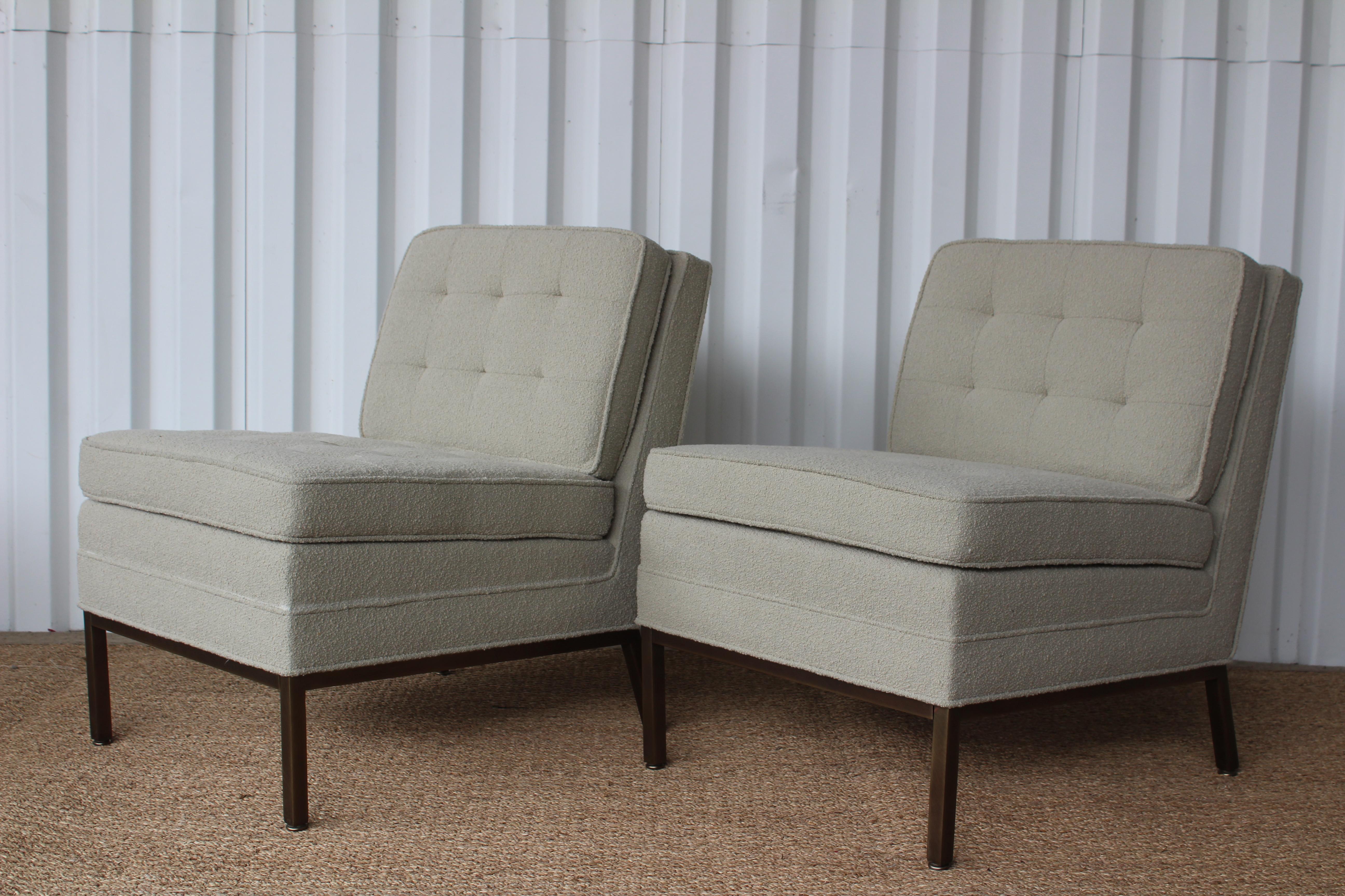 Pair of in the style of Florence Knoll armless slipper chairs, in the style of Florence Knoll for Knoll in the 1950s. The pair have been completely restored. The attached cushions have been reupholstered in a Classic Knoll bouclé. The bases have