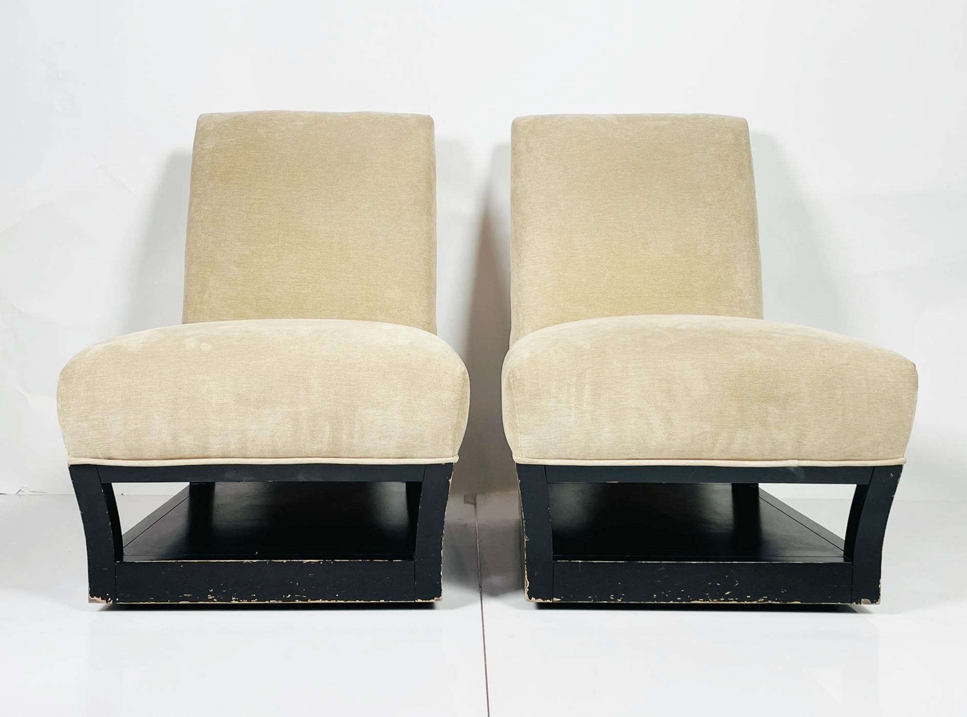 Beatiful pair of slipper chairs designed by John Hutton and manufactured in the USA by Donghia.
The chairs have beautiful lines, the base has an integraded shelf that can be use as a magazine holder or even as a shoe storage when the chairs are