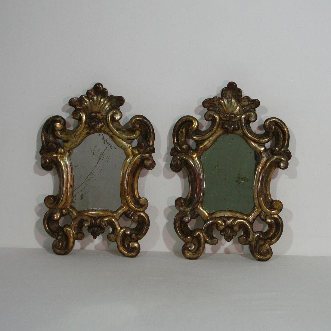 Great pair of small Baroque giltwood mirrors, Italy, circa 1750-1800. Weathered, small losses and old repairs.