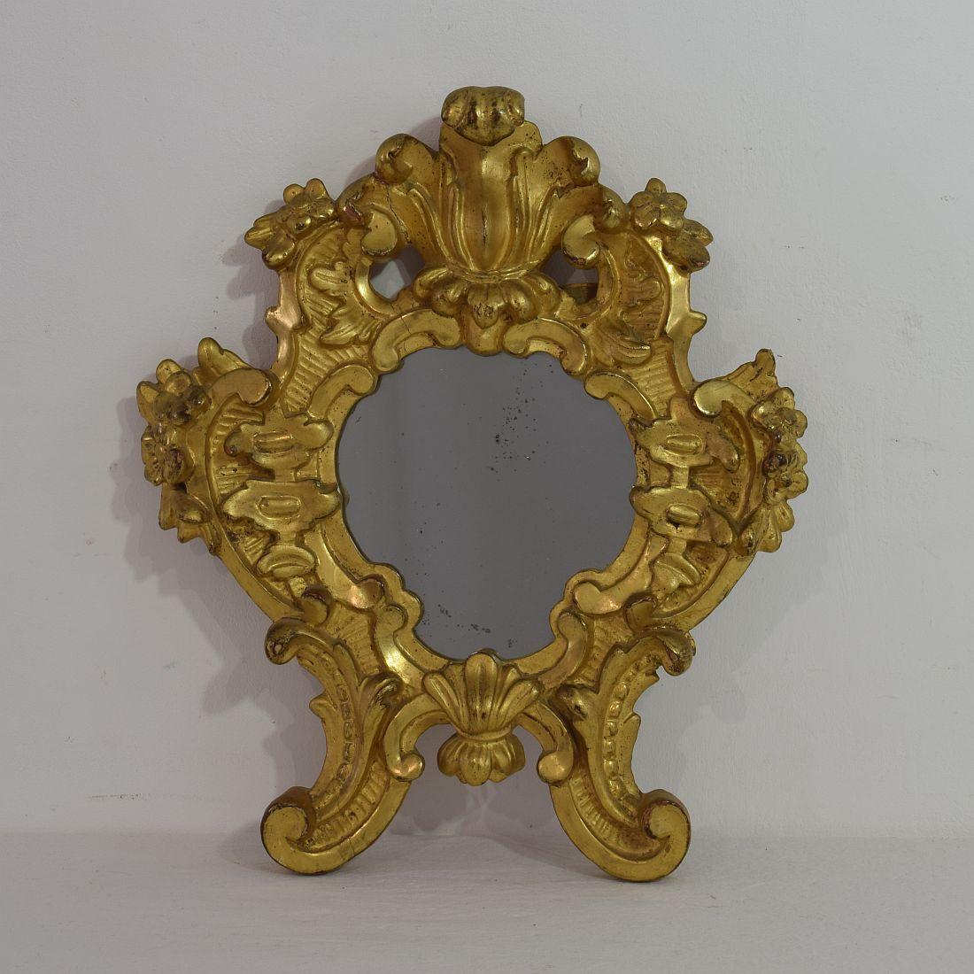 Beautiful pair of small carved giltwood Baroque mirrors, with beautiful old mercury mirror glass,
Italy, circa 1750. Weathered, small losses and old repairs, but very good condition.