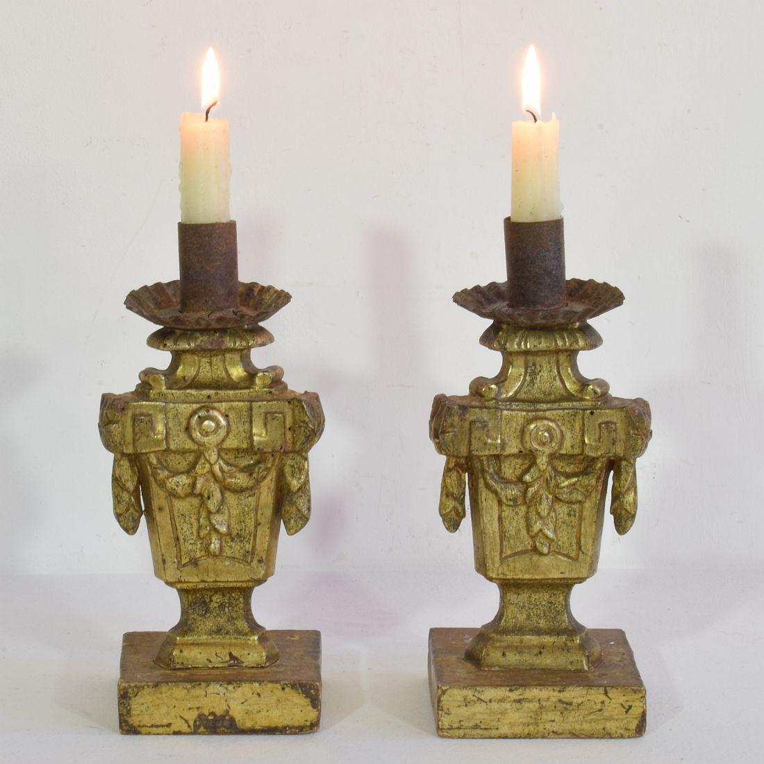 Unique small pair of neoclassical wooden candleholders with their old gilding,
Italy, circa 1760-1780. Weathered, small losses and old repairs. Measurement each.