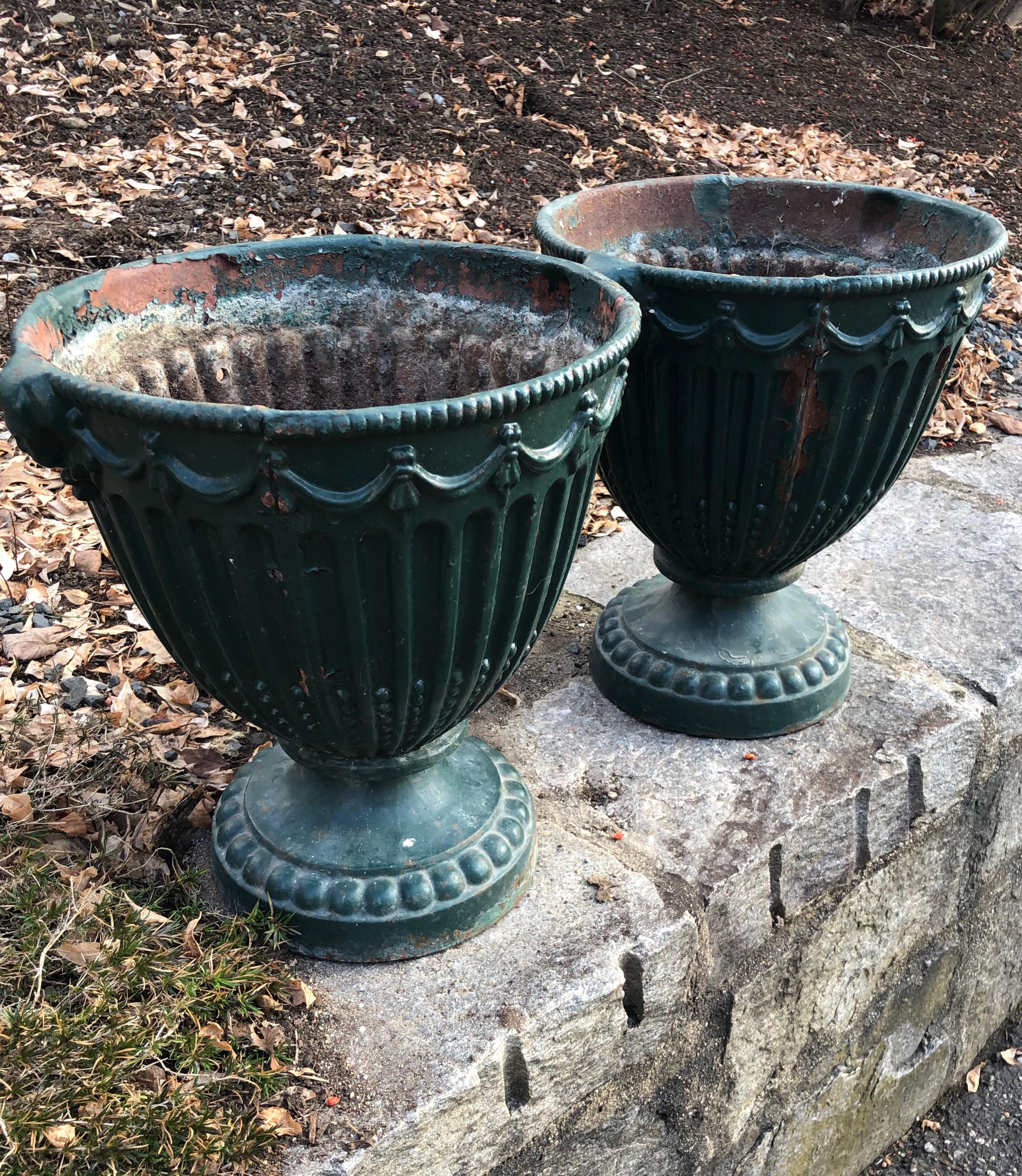 These charming urns are the perfect accent pieces for your tabletop. Made of cast iron and dating to the late 19th Century, they are in very good antique condition overall, with only a bit of missing paint and mild surface rusting to the outside.