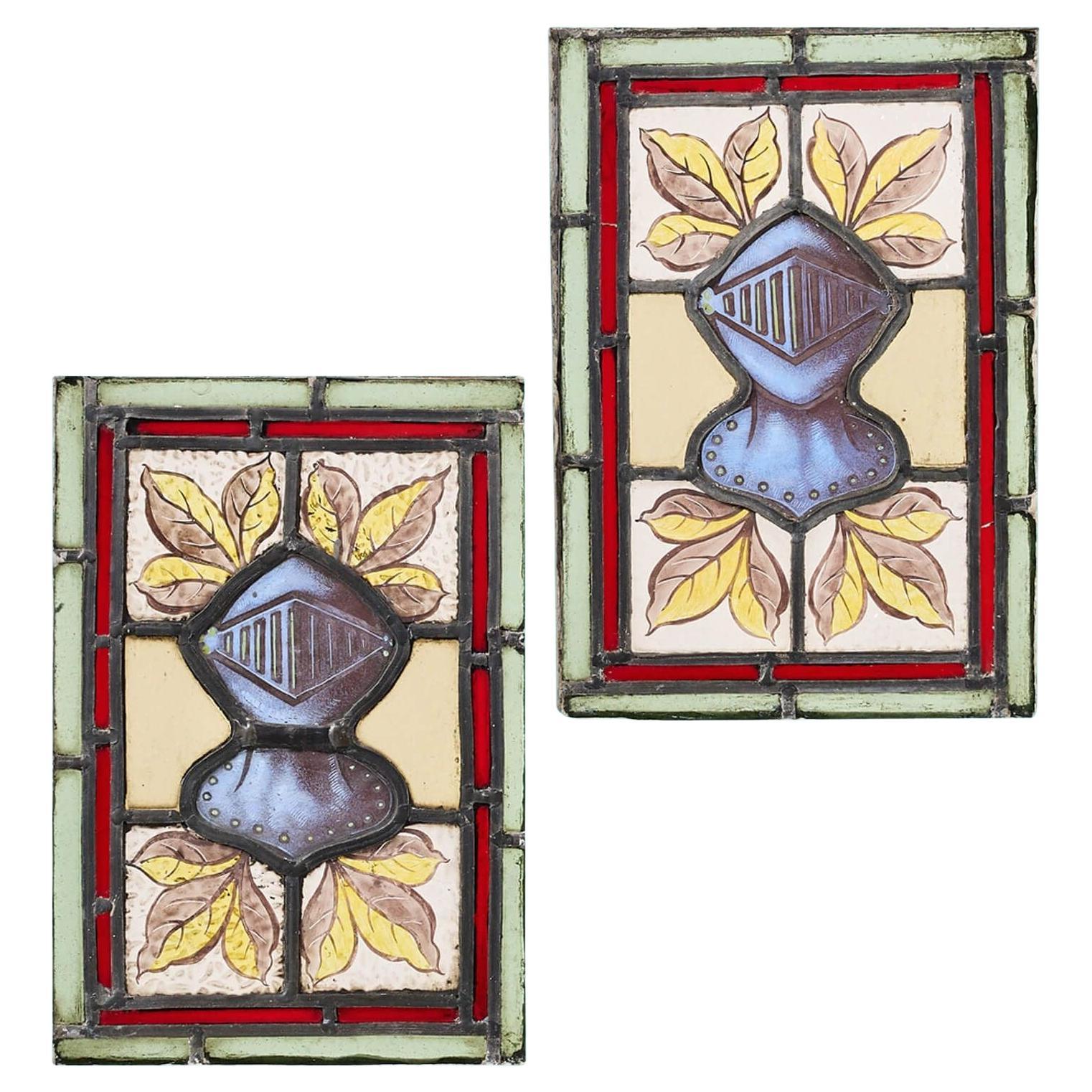 Pair of Small Antique English Stained Glass Windows Depicting Knight Helmets For Sale