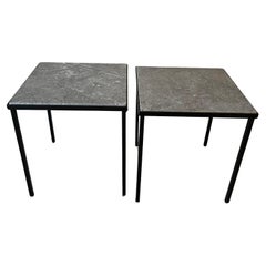 Pair of small black metal and stone side tables.