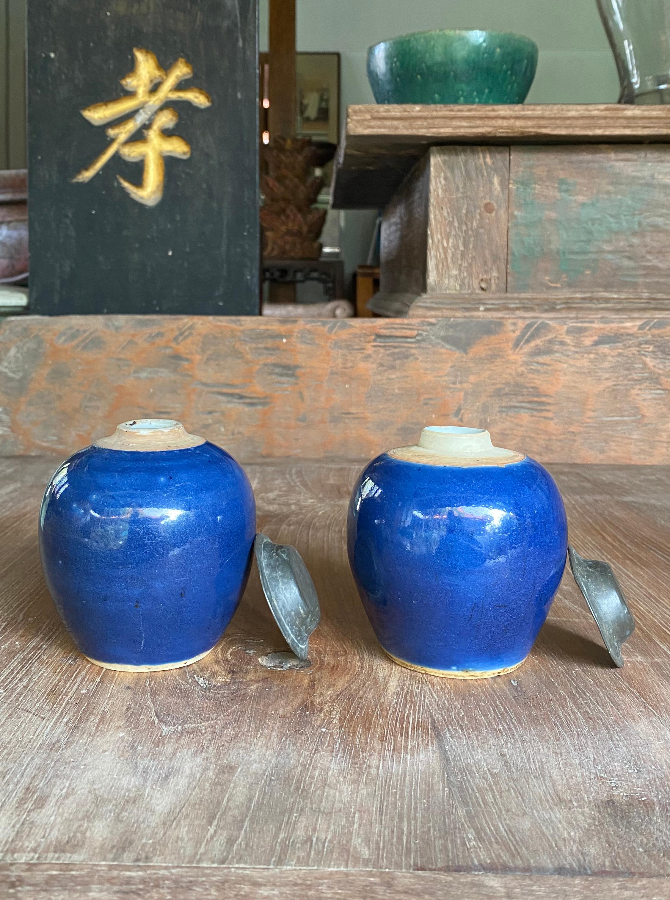A pair of small blue Chinese ceramic ginger jars with metal tops dating to the early 20th century 

Dimensions: Height 10cm x Diameter 8.5cm each.
 