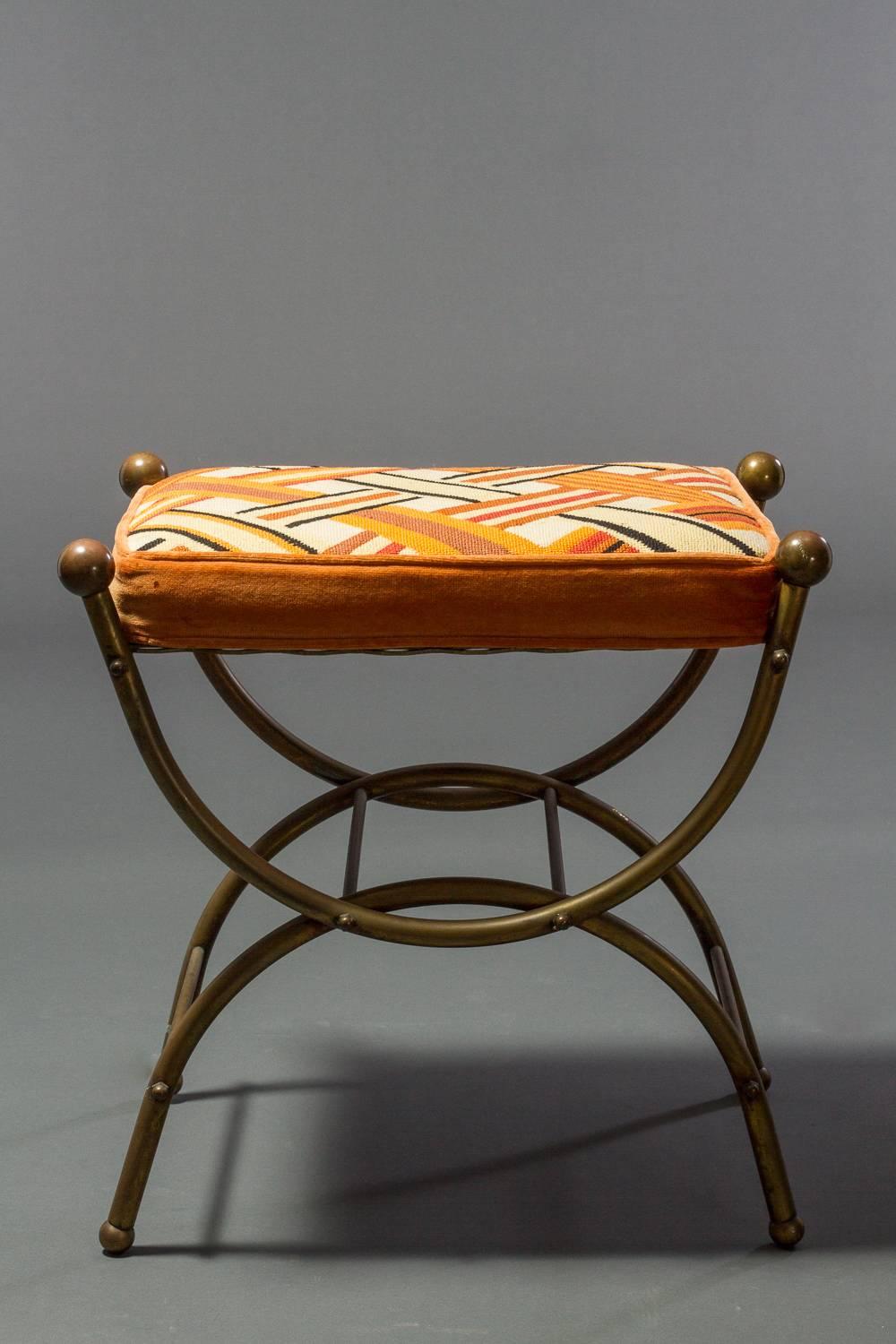 Pair of small stools or benches. Bronze with cross stitched cushions.