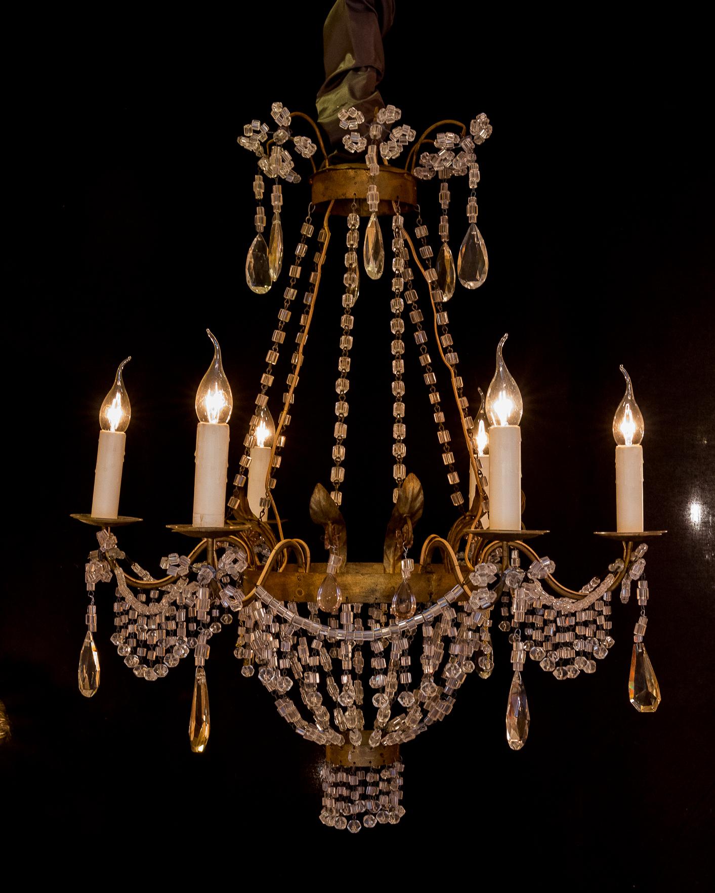 Pair of small chandeliers, brass and handcut crystal, 19th century.

An elegant and decorative small pair of basket chandeliers, in guilt-brass and handcut crystal, in the Classic Empire style. Fine quality cut-crystal decoration with pearls