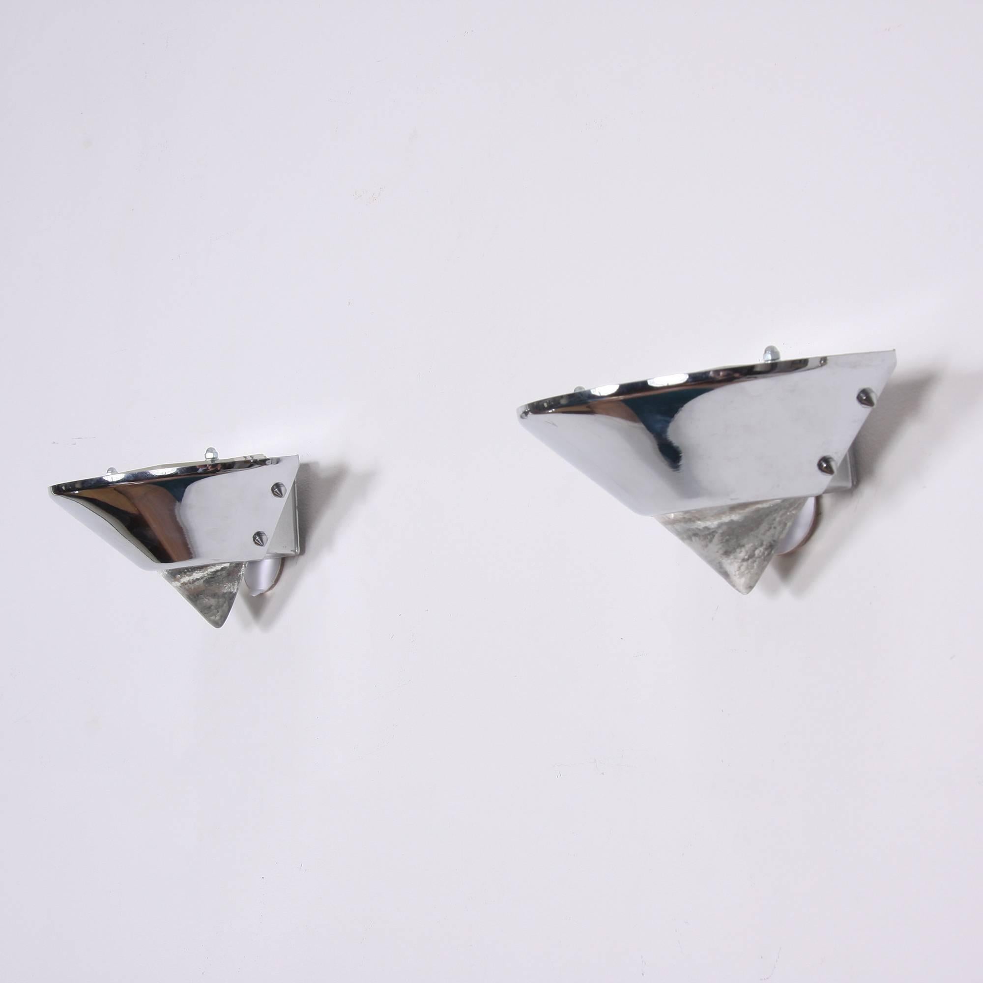 German, circa 1980

A pair of uplighter wall lights in a triangular shape. Solid glass on the lower part with a chromed metal upper part. Includes re-wiring.