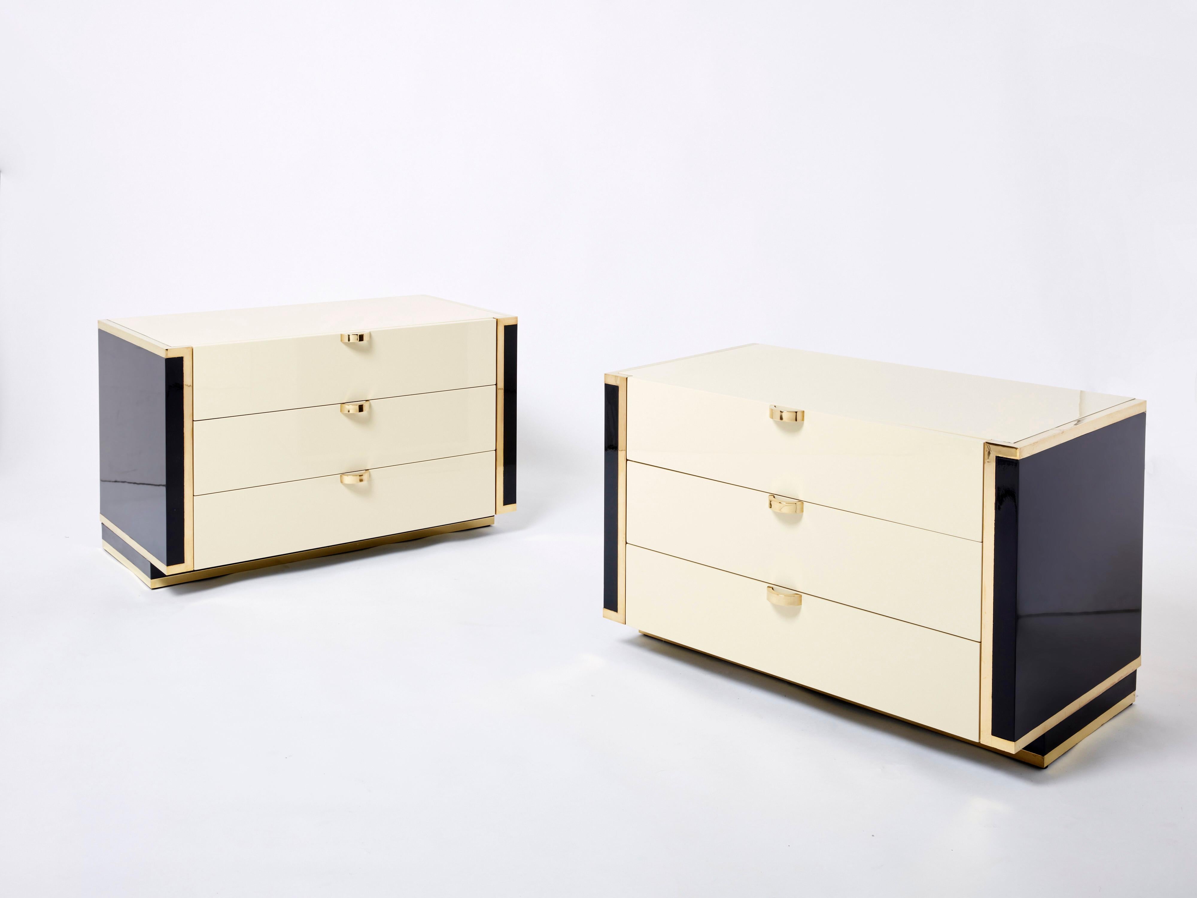 These twin small chest of drawers in a beautiful cream and black lacquer could serve spacious nightstands in a bedroom, sturdy end tables in a living room or office, or as small commodes in a bedroom dressing room. The crisp mix of light cream and