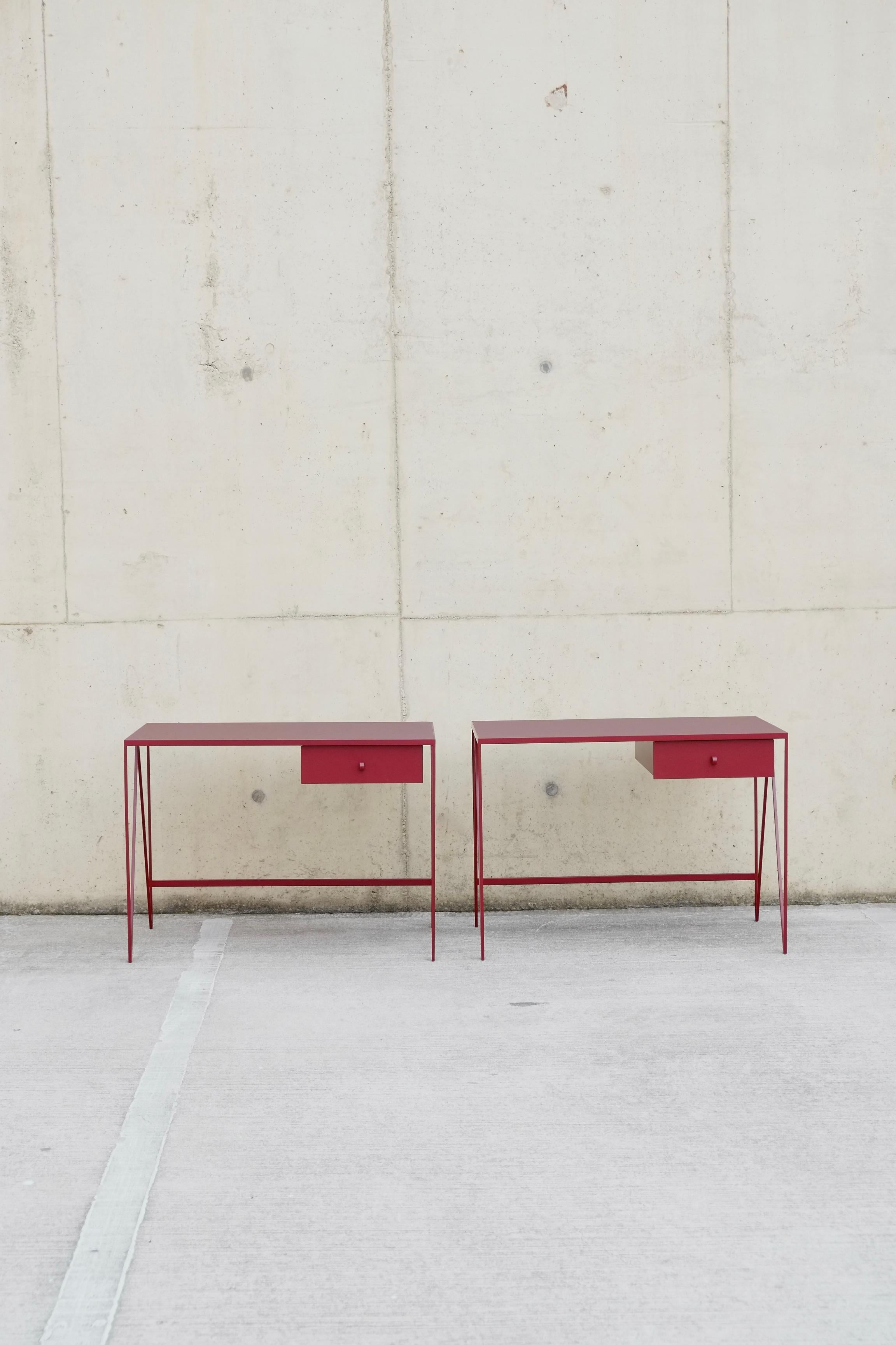 This pair of small study desks are made with a beetroot powder-coated steel frame and a burgundy coloured natural linoleum tabletop. The linoleum for our desks is selected for the ecological properties of the linseed of which it is made. It also has