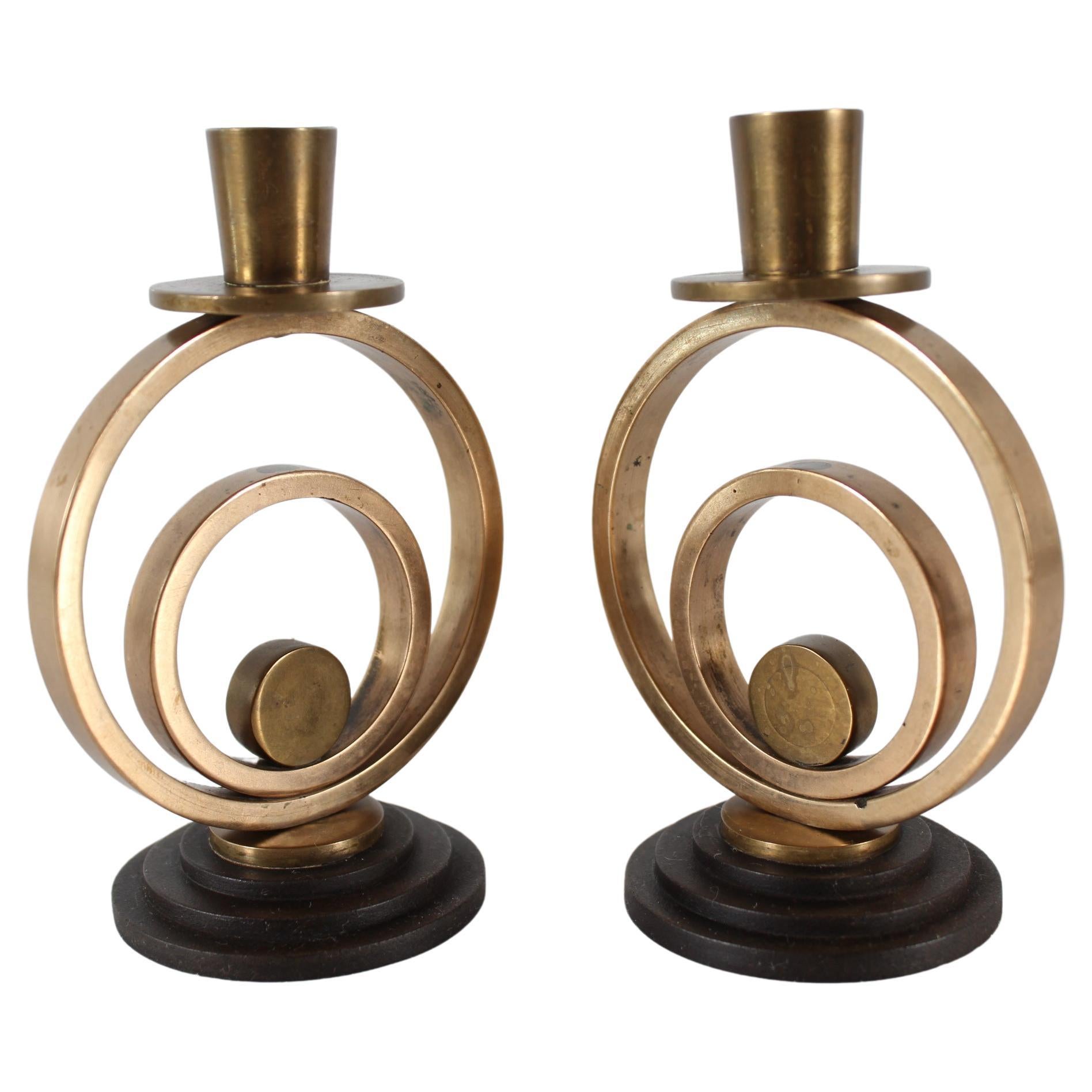 A pair of small Danish Art Deco candlesticks made of patinated brass on feet of turned bakelite-like material.
Designed and made in Denmark in the 1940s

Very nice used condition with good patina.