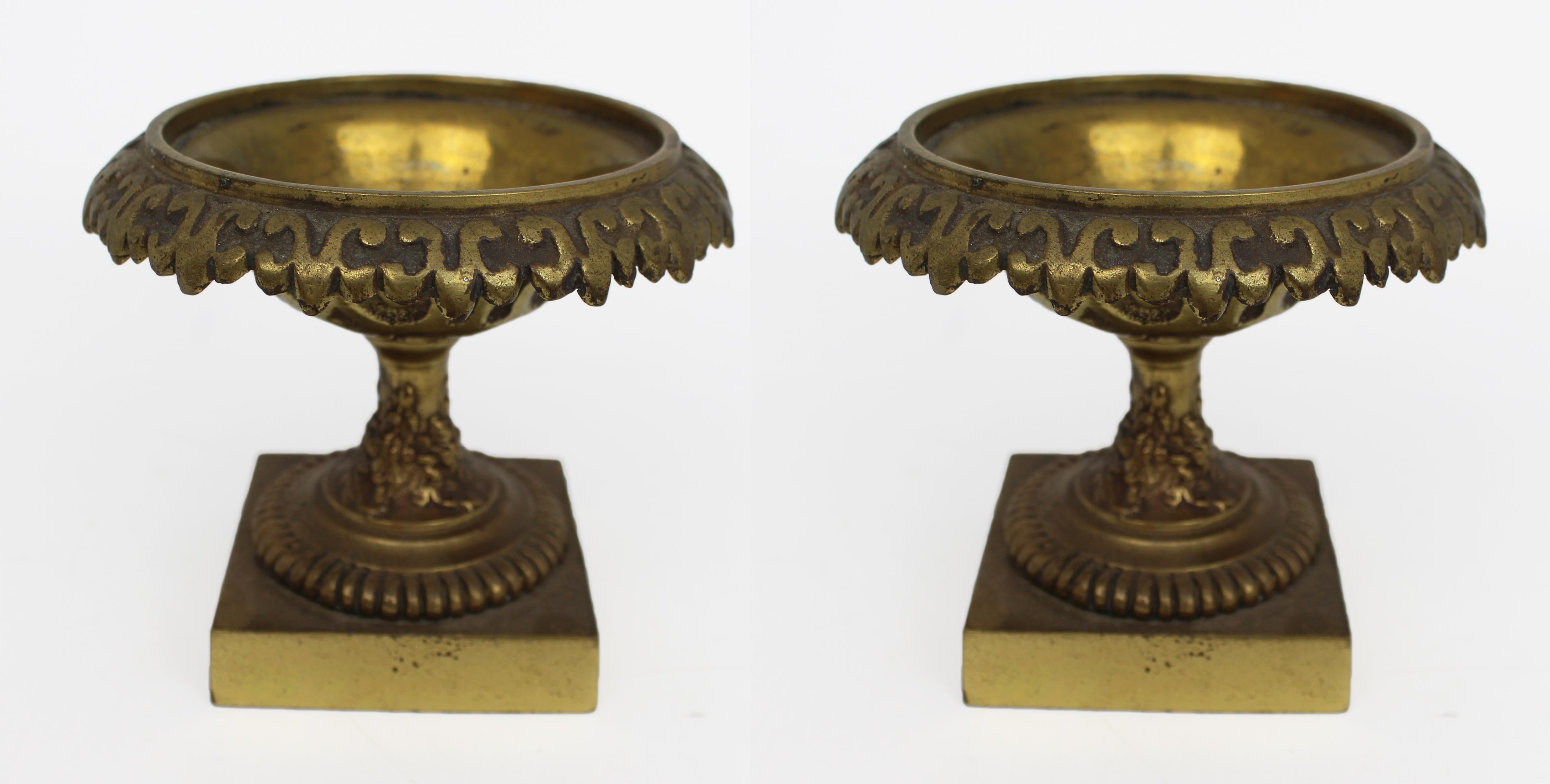 Pair of Small Early 19th Century Grand Tour Bronze Urns

A decorative and finely cast pair of small Grand Tour bronze urns, dating to the early 19th century.
Each of classical form with a flared rim featuring stylised foliate ornament and a rounded
