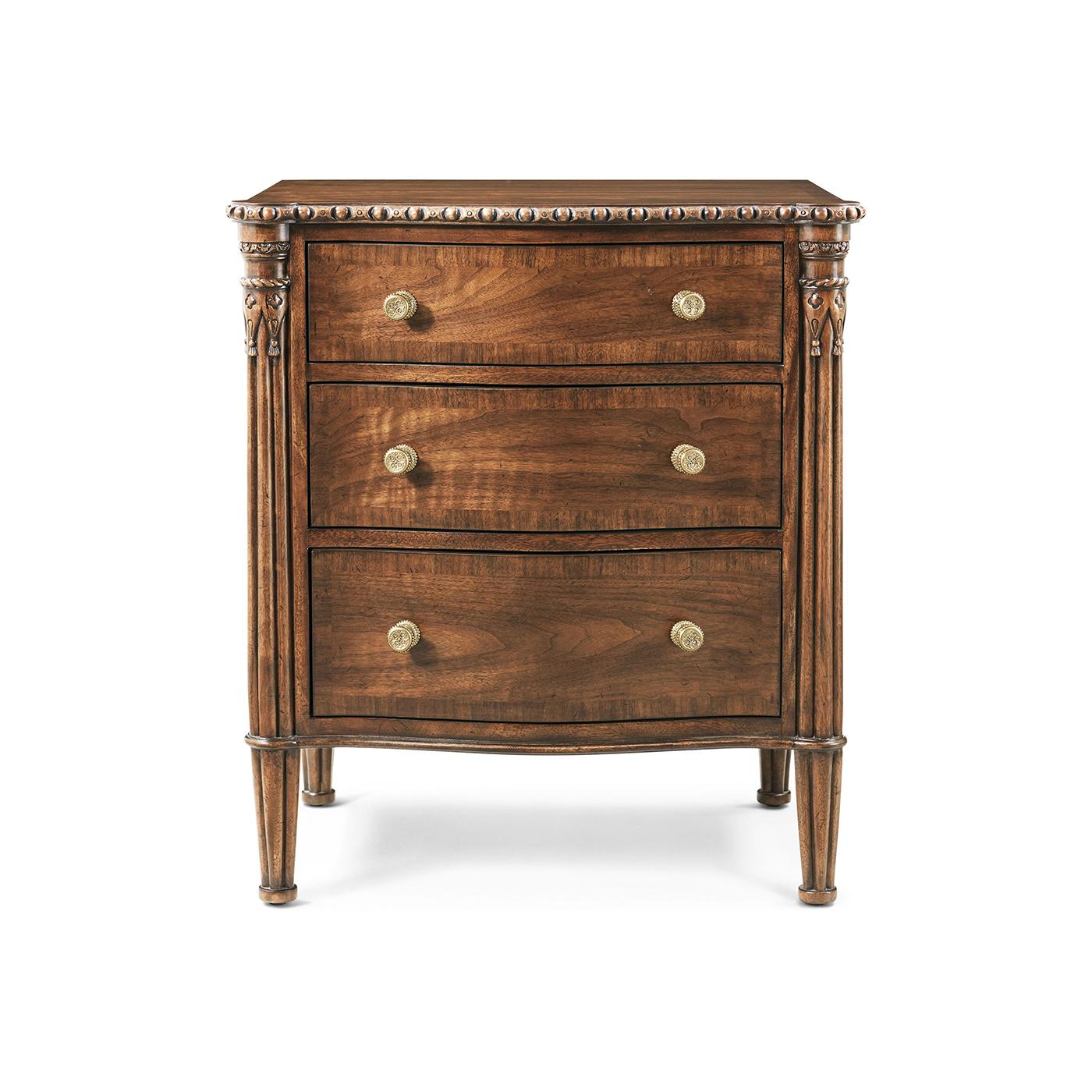 L'élégante façade serpentine crée une silhouette fluide, complétée par trois tiroirs spacieux à bandeau croisé qui mettent en valeur un travail du bois et un équilibre magistral.

Fabriquée en bois figuré dans une chaude finition noyer, cette