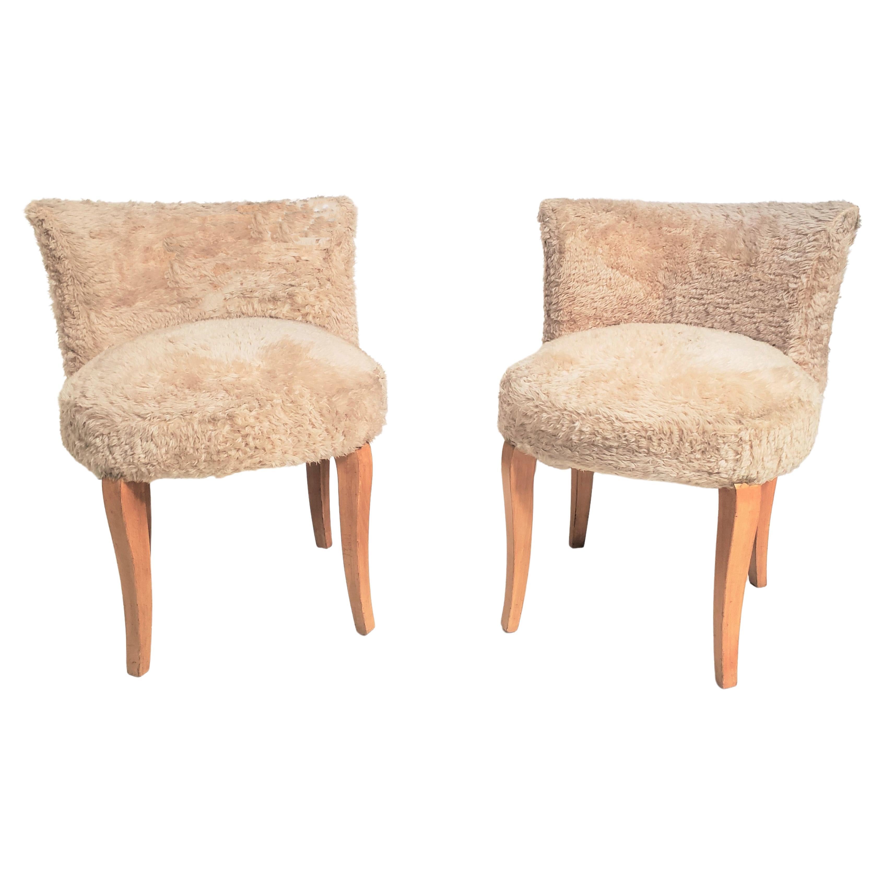 Pair of French 1940s petite boudoir chairs. These charming accent chairs feature a curved backrest and stand gracefully on delicate sycamore wood cabriole legs, in the style of Dominique. Since they have backs, the chairs offer exceptional comfort
