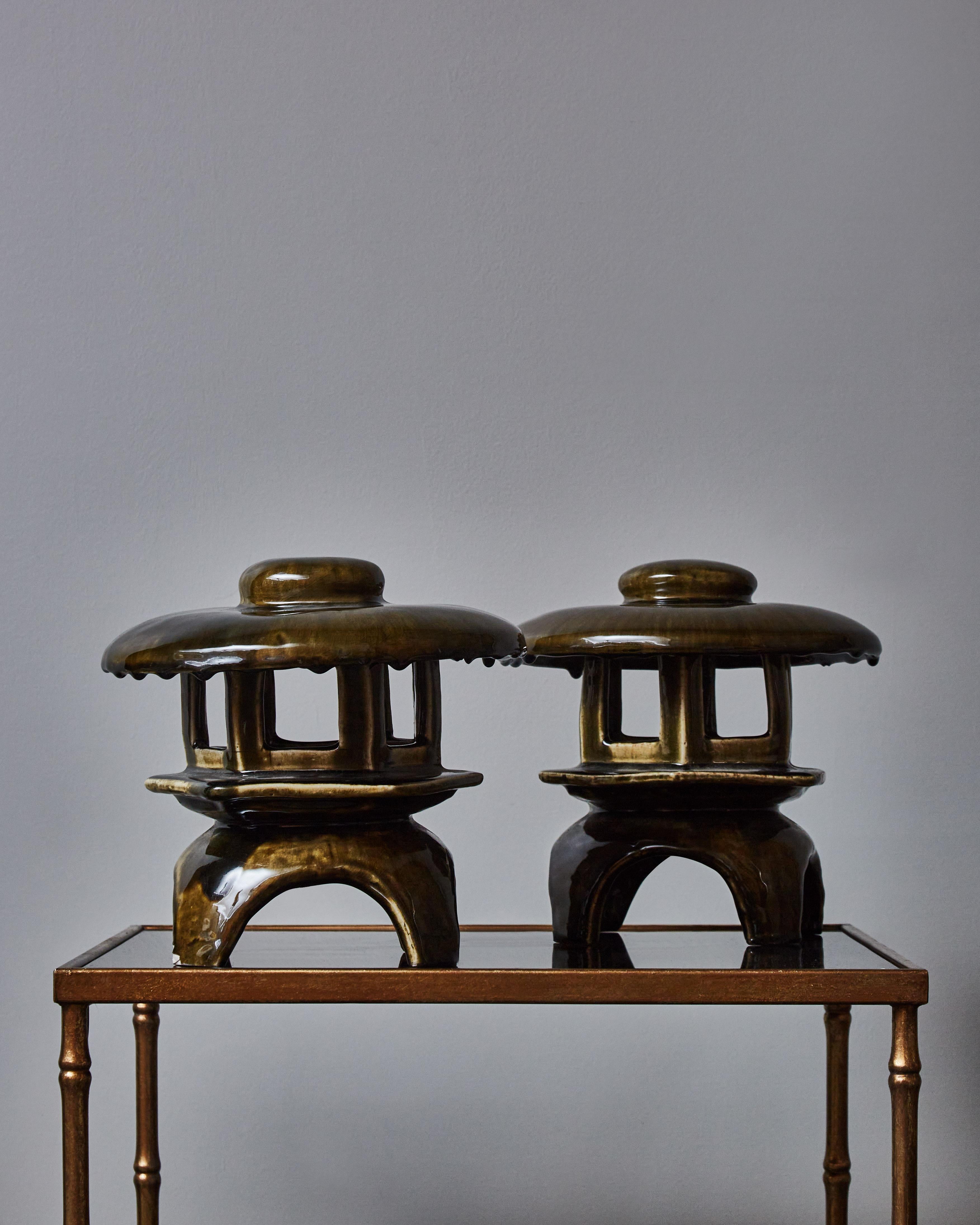 Pair of charming little table lamps shaped like pagodas, glazed in dark green with accents of beige and brown.