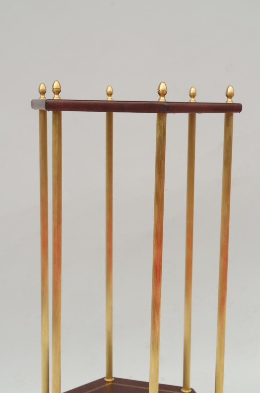 Pair of small gilt brass side tables. Two hexagonal leather tops, highlighted in gold, stand on six caned feet.
Contemporary work.