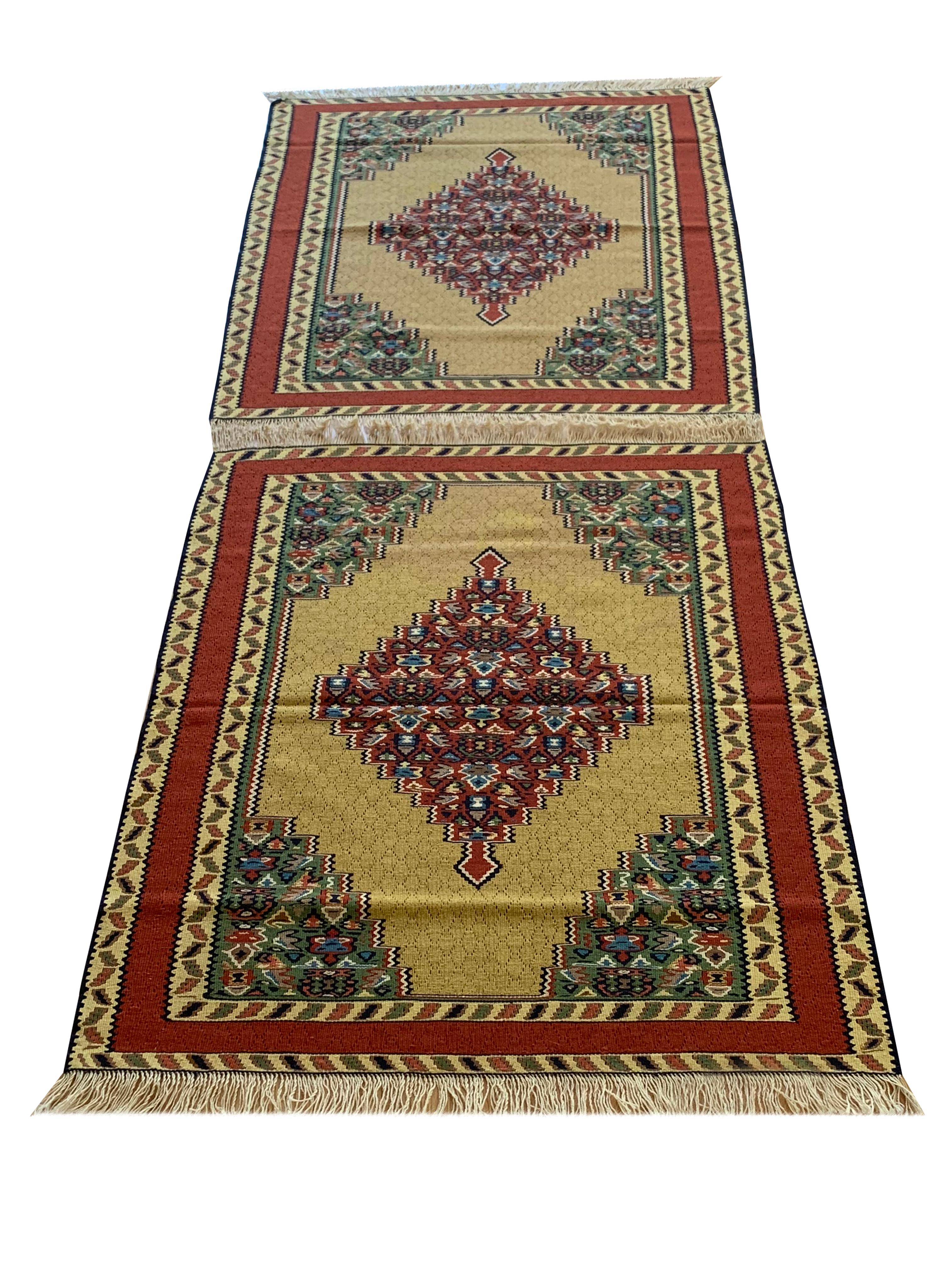 These beautiful Rugs are handmade, flatwoven kilims woven in the early 21st century, circa 2010. It is unused and so is in excellent condition. The design features a bold yellow background that has been decorated with an intricate decorative