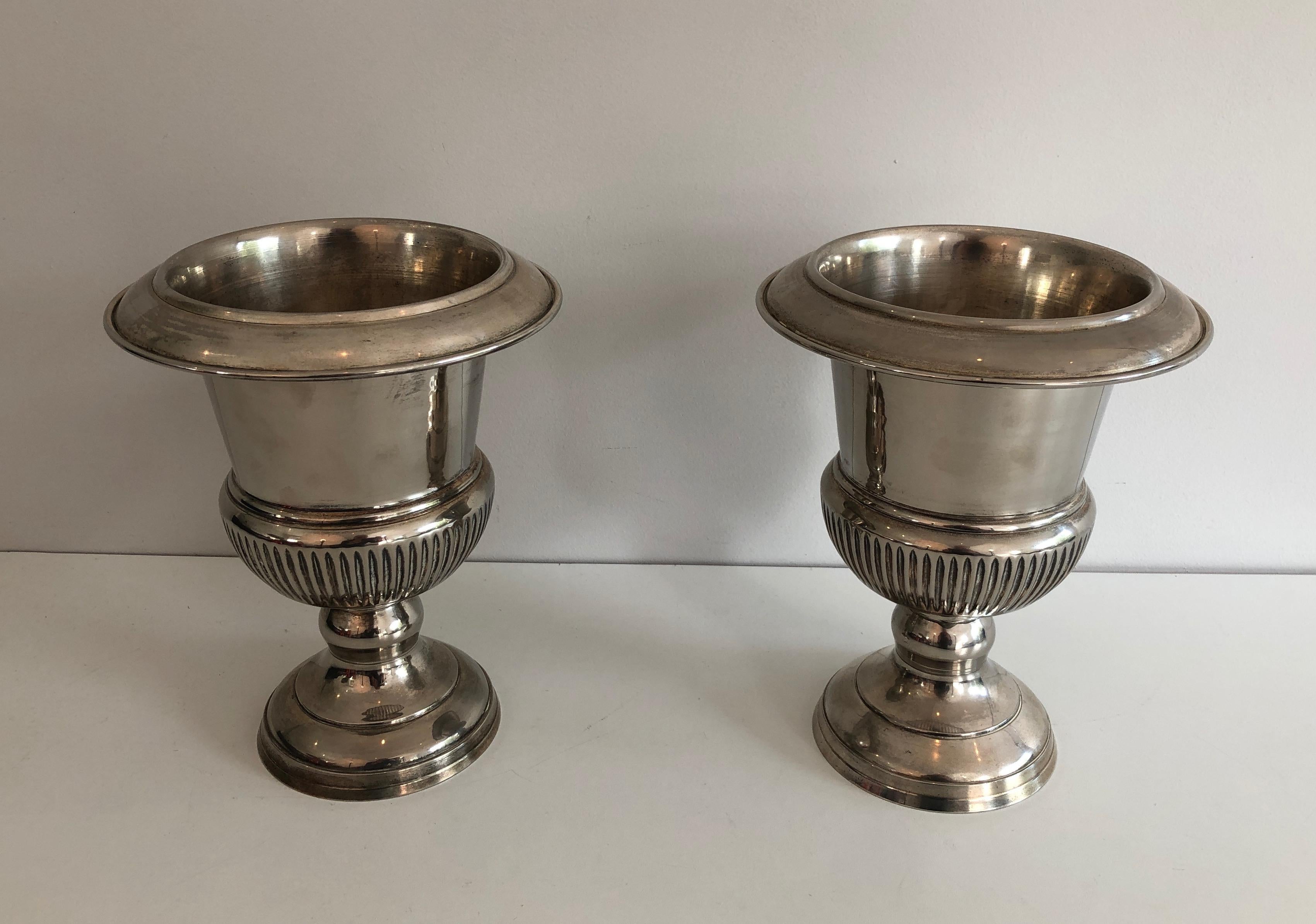 This pair of small Medicis style champagne buckets is made of silvered metal. This is a French work. Circa 1940.