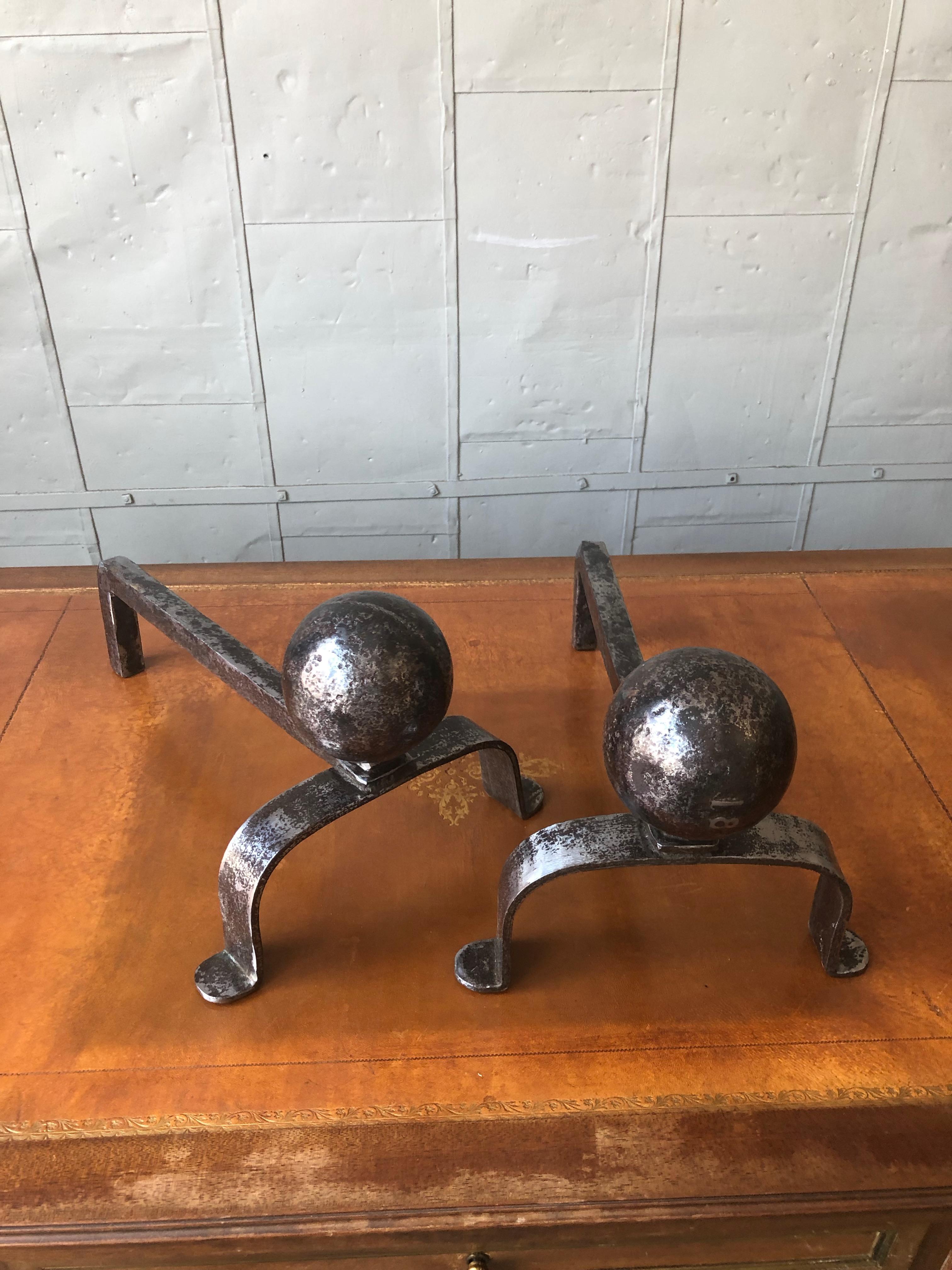 An interesting pair of Art Deco style andirons made of polished iron with oversized decorative cast iron balls mounted on a base with cabriolet feet. French, 1920s.

Ref #: D0819-02

Dimensions: 9“H x 10¼”W x 16”D