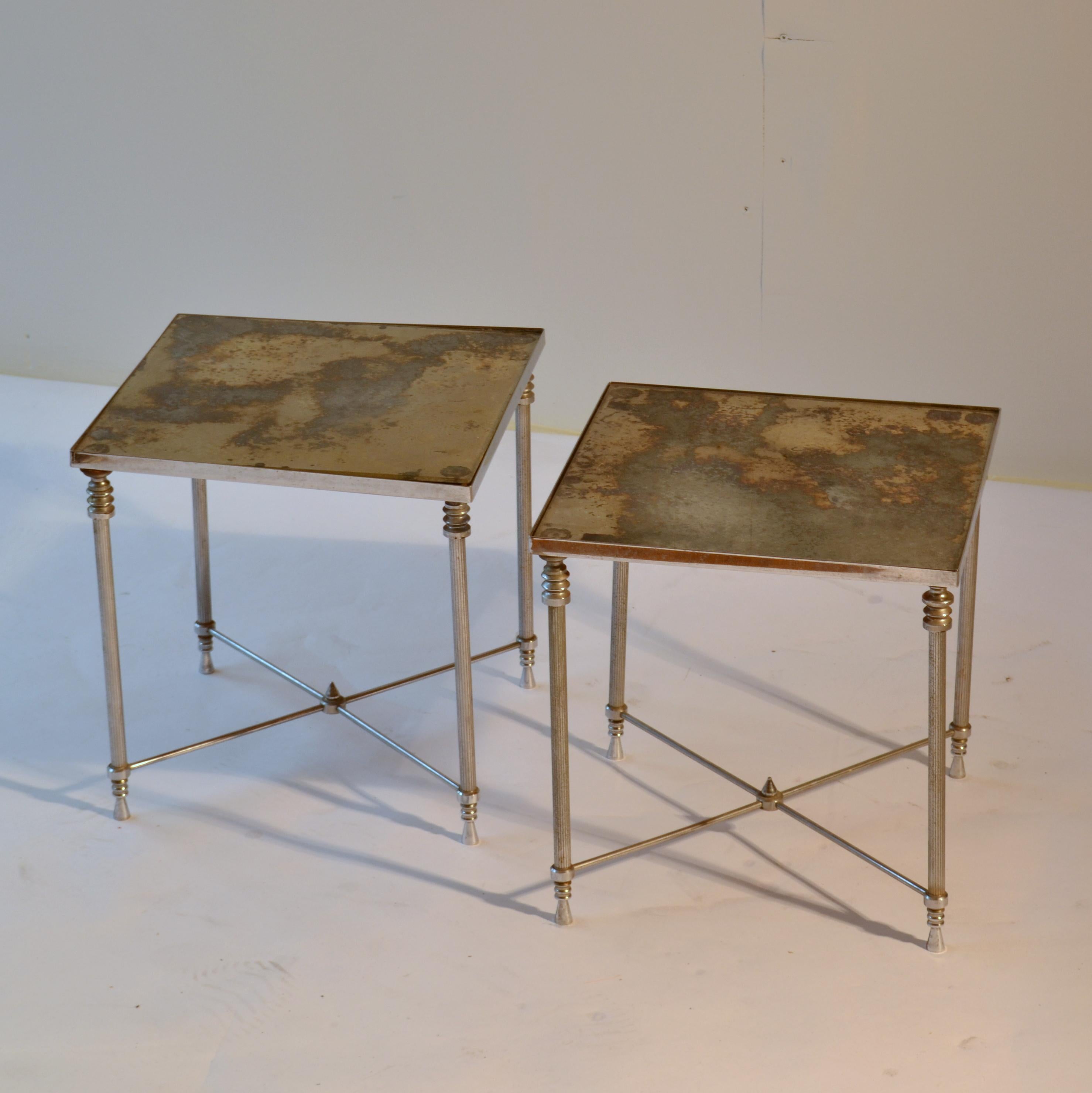 Square side or end tables with nickel plated brass frames and distressed mirror tops. They are in the style of Maison Baguès & Charles and date to the 1970s.