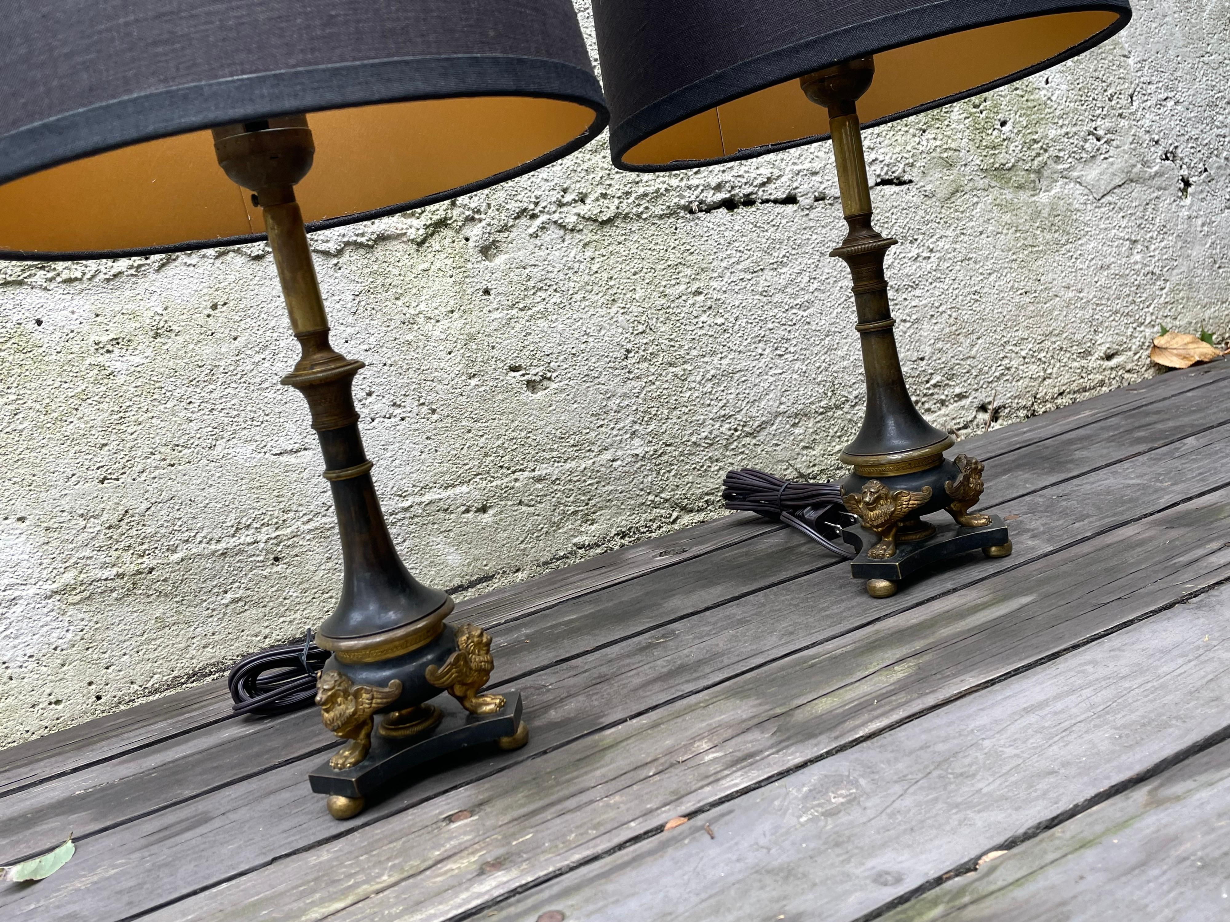 Stunning pair of French bronze small scale table lamps. Assembled with modern elements and shades, these vintage lamps make striking fixtures for a bedroom, library or study. Professionally rewired and new shades included. 12.50 to top of socket,