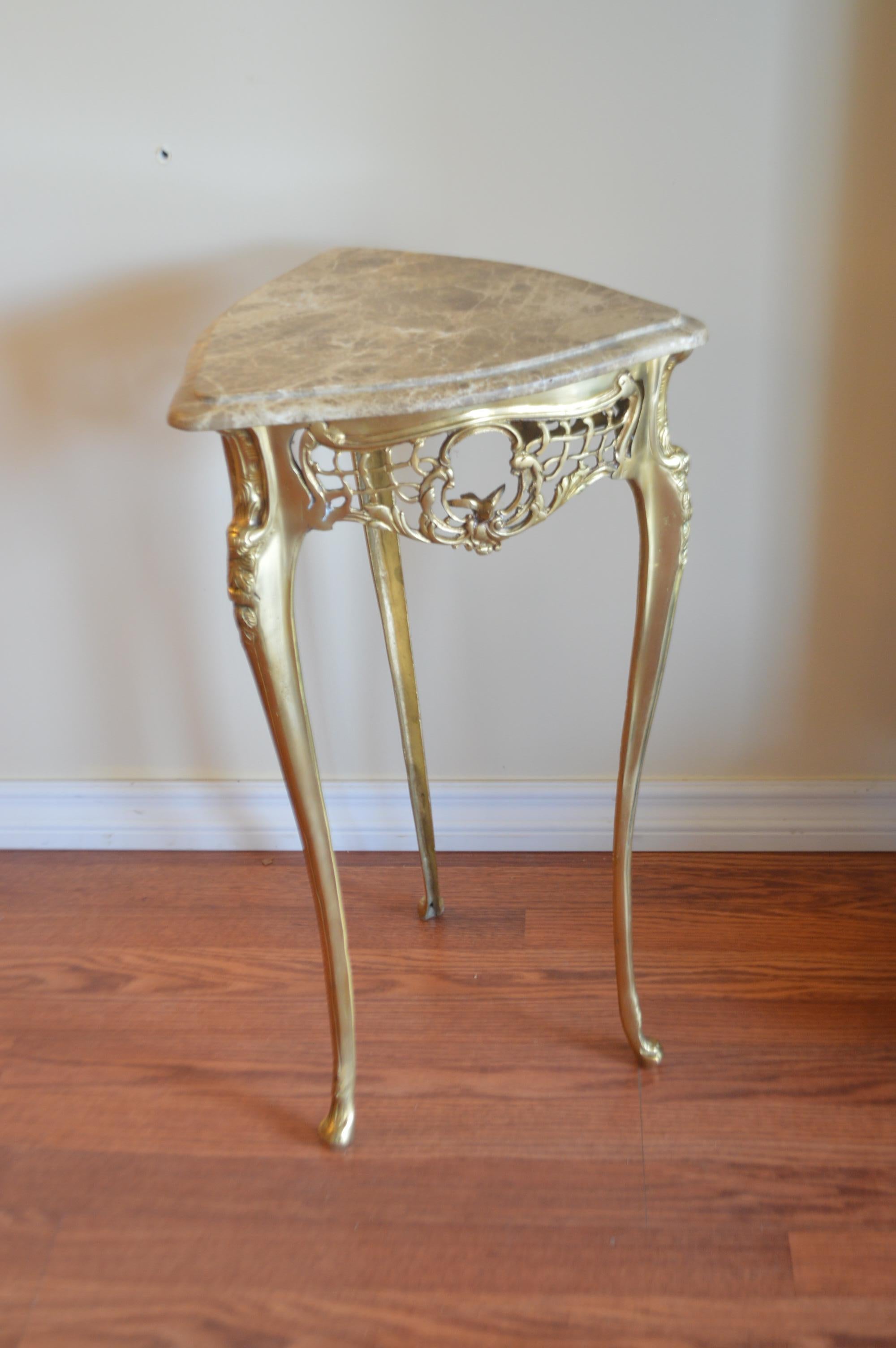 Most unusual pair of small side tables, triangle shape with attractive marble tops. The gilded bronze base is highly decorative with a lace design apron holding a small bird on each side of the table. The legs are fine and elegant.
The type of