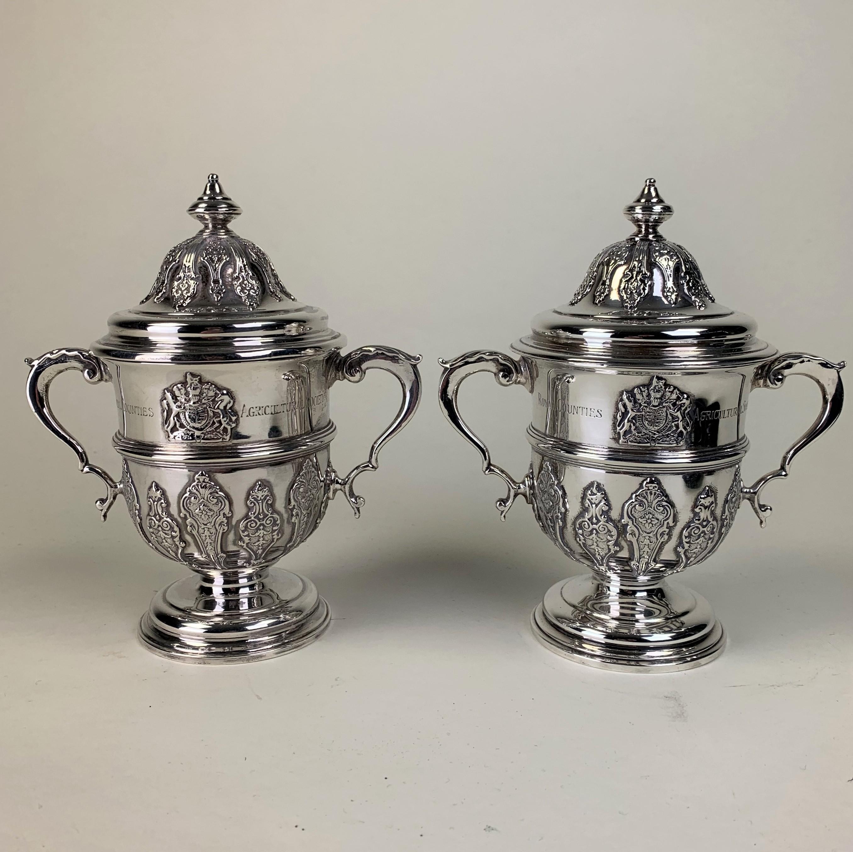 A very fine quality pair of silver Trophy Cups with lids and scrolled handles presented by the Royal Counties Agricultural Society. Each engraved 
