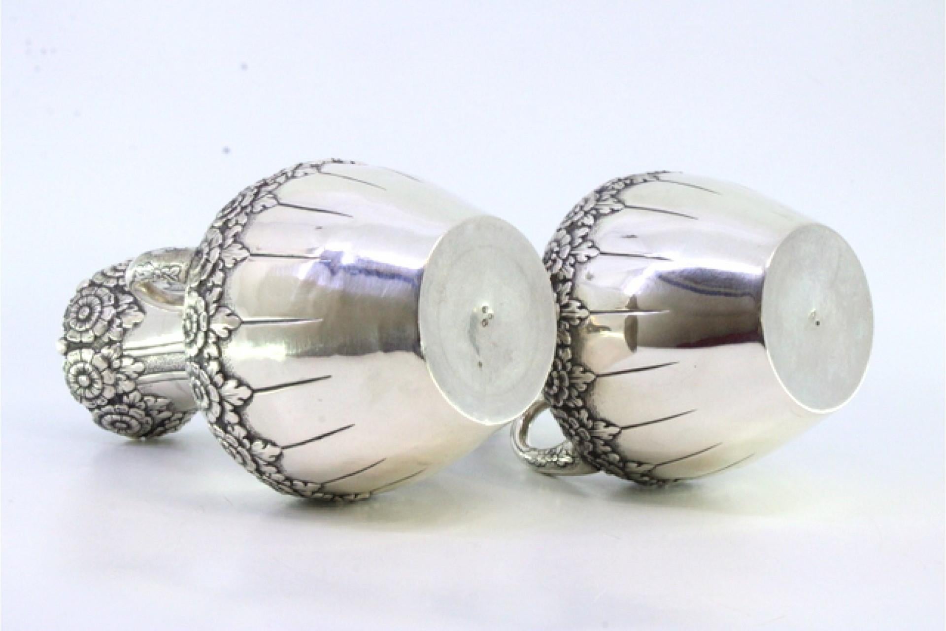 European Pair of small silver jugs with floral motifs and embossed garlands For Sale