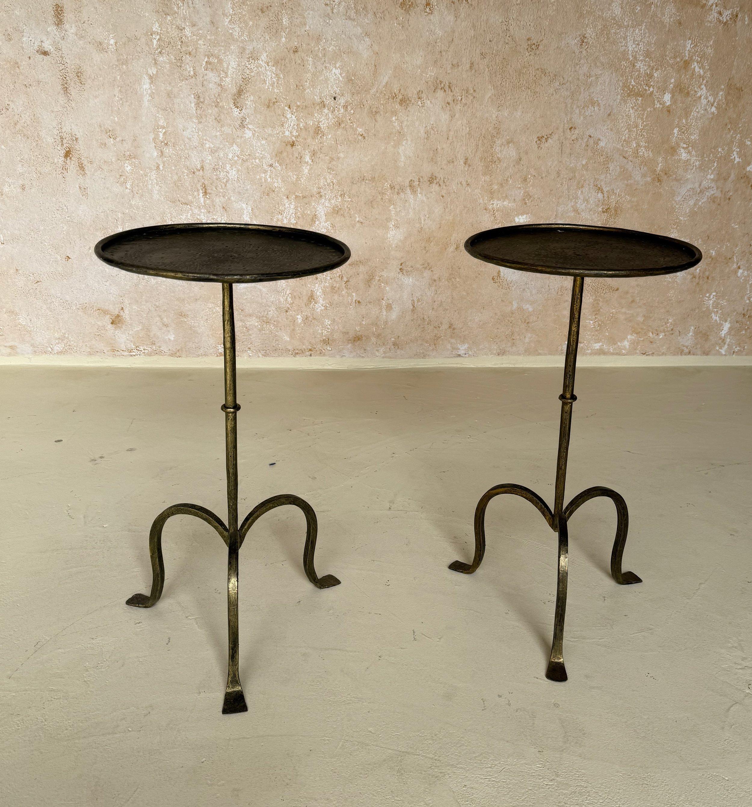 This elegant pair of small Spanish end tables was recently handcrafted by skilled European artisans using traditional iron-working techniques and materials. Inspired by a vintage design from the 1950s, each table features an elegant central stem