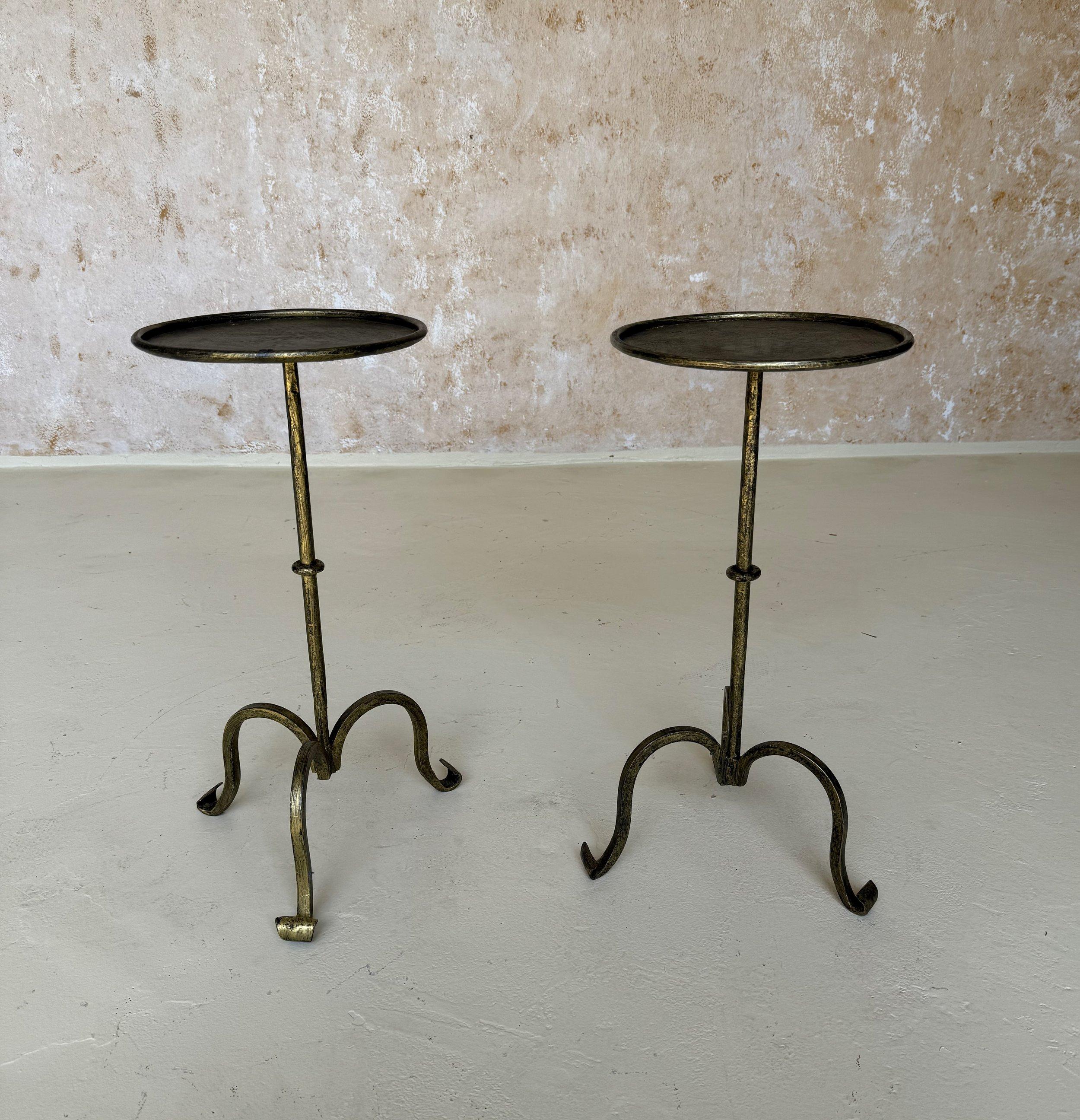 This charming pair of small Spanish side tables was recently handcrafted by skilled European artisans using traditional iron-working methods. They feature a central ring accent on the stems and gracefully curved tripod bases with scrolled feet. The