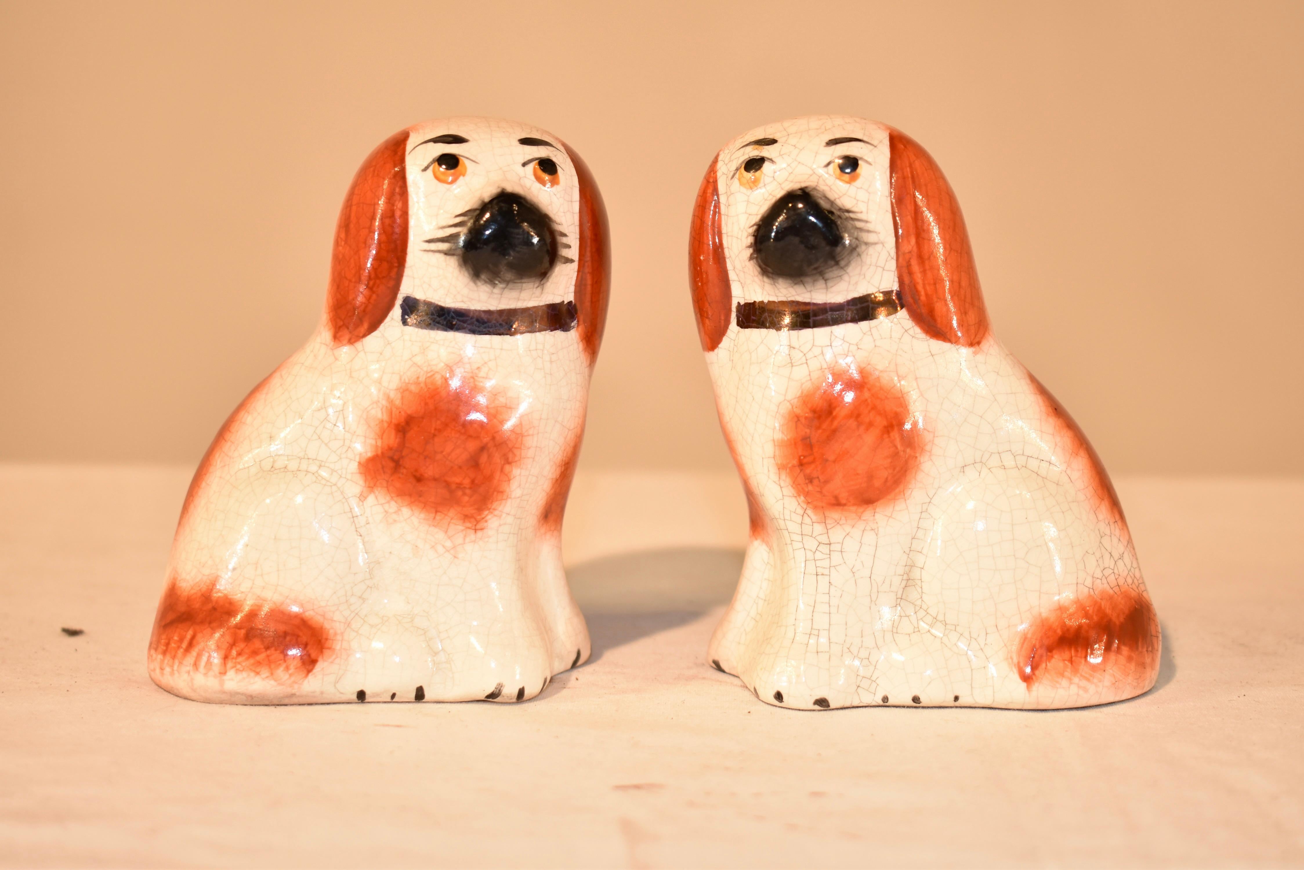 Pair of small rust and white Staffordshire dogs from England, circa 1970s.
