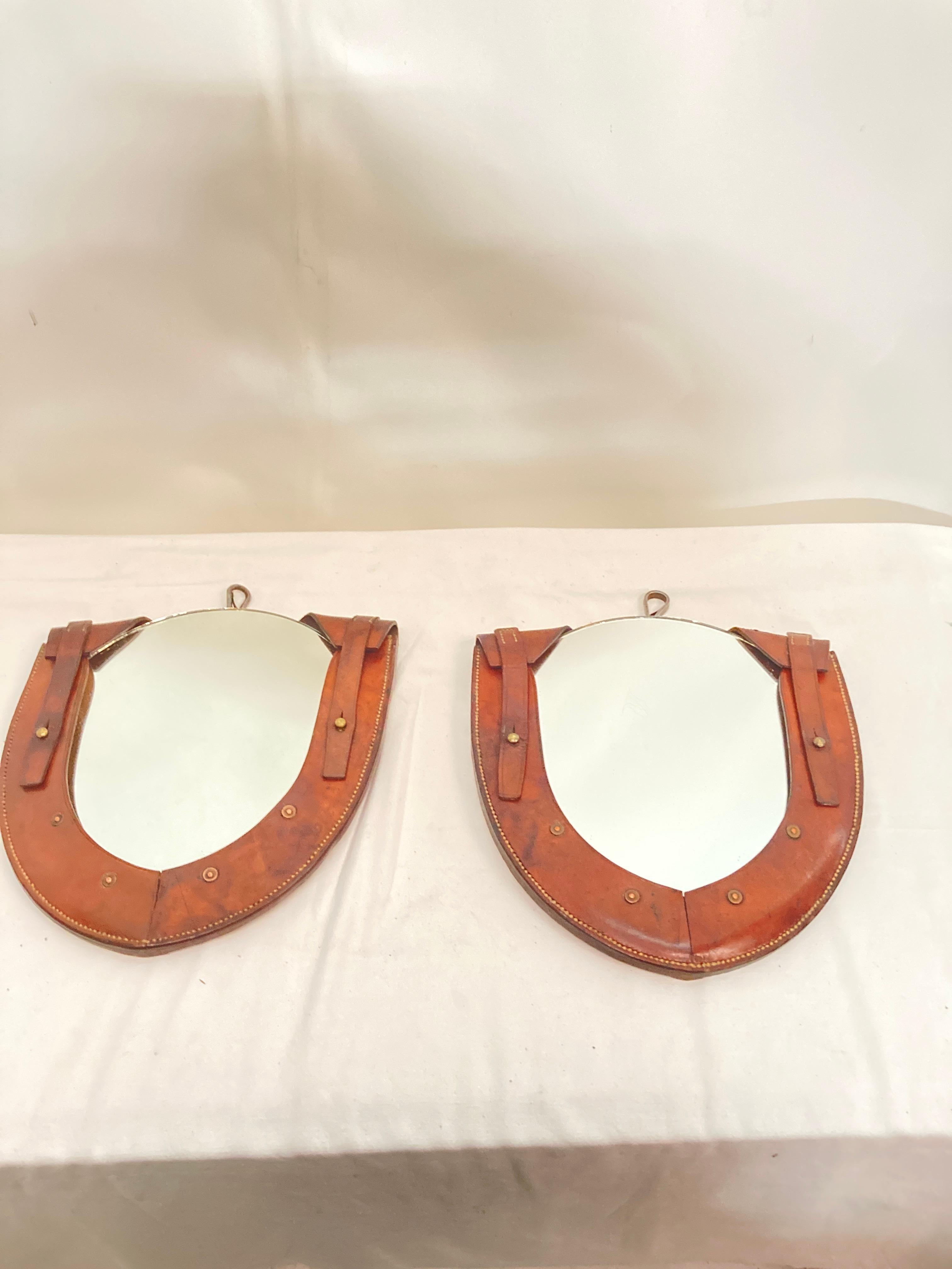 Pair of small stitched leather wall mirror
1950's
France