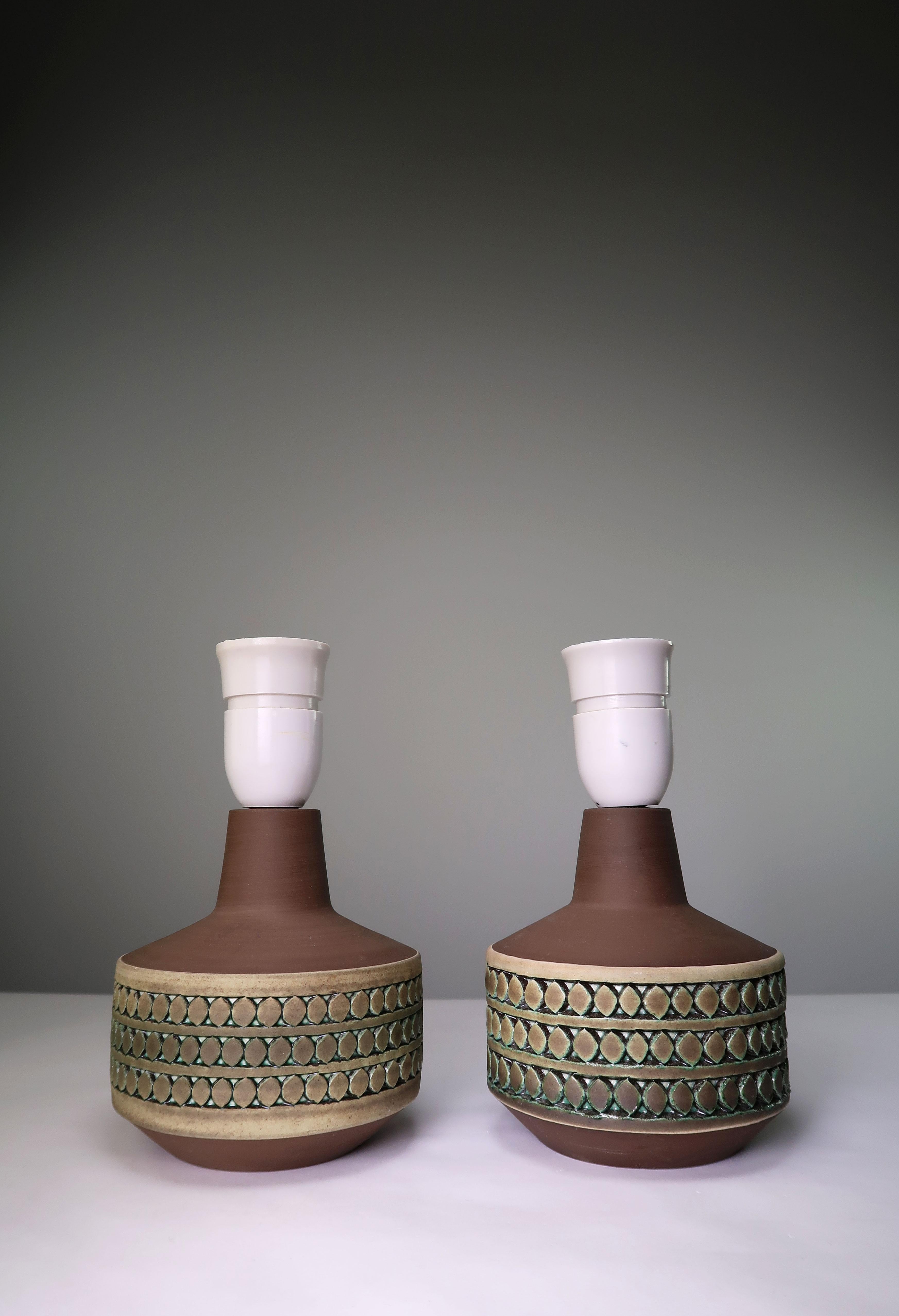 Set of two small Scandinavian Mid-Century Modern handmade ceramic table lamps by acclaimed ceramic artist and writer Tomas Anagrius from Stockholm. Manufactured in the small Swedish town of Kvidinge in the late 1960s. Raw neck and base with hand